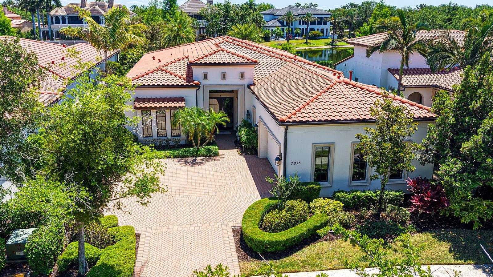 Set behind the gates of the coveted Lake Club in Lakewood Ranch, this award-winning residence captures the essence of refined lakefront living. Inspired by classic Tuscan architecture, the neighborhood impresses with its picturesque bridges, tranquil water features, and winding lakes that create a truly distinctive backdrop.A three-time Parade of Homes winner, this former Adalia model by London Bay Homes offers an exceptional blend of design and livability. Positioned along the water with over 60 feet of lake frontage, the home is designed to maximize both views and privacy from its expansive lanai, complete with a pool and spa for year-round enjoyment.Located within the intimate Matera enclave—The Lake Club’s only maintenance-free section—residents enjoy a low-maintenance lifestyle with comprehensive exterior care included, allowing more time to relax and enjoy the surroundings.Inside, the home unfolds with a thoughtfully crafted floor plan that lives effortlessly. Featuring 3 bedrooms, 3 bathrooms, and a flexible study, the layout provides both comfort and versatility. The study easily serves as a guest space, enhanced with motorized blinds on the French doors for added privacy.Walls of glass draw you toward the outdoors from the moment you enter, where 10-foot sliding doors frame serene water views and fill the home with natural light. The open great room seamlessly connects to the kitchen and dining areas, creating a space that is equally suited for quiet evenings or lively gatherings. Elevated ceilings and timeless finishes add to the home’s sense of openness and sophistication.Each bedroom is designed as its own private retreat, including a reconfigured third bedroom with en-suite access. The primary suite offers a peaceful escape, now complemented by newly installed motorized shades for effortless comfort and ambiance.Built with efficiency and durability in mind, the home is Green Certified and features impact-resistant windows and doors along with whole-home icynene insulation. A series of thoughtful upgrades enhance both function and style, including updated dishwasher, an outdoor kitchen bar fridge, smart climate controls, lanai sunscreens, and a finished garage with epoxy flooring and custom storage.Life at The Lake Club extends far beyond the home, offering residents access to a private, amenity-rich environment with 24/7 guarded entry. From the elegant clubhouse and resort-style pool to fitness, tennis, pickleball, and scenic outdoor spaces, every detail is designed to support an active and social lifestyle.All of this is set within Lakewood Ranch, one of the nation’s most celebrated communities, known for its vibrant dining, shopping, top-rated schools, and close proximity to the Gulf Coast’s renowned beaches.