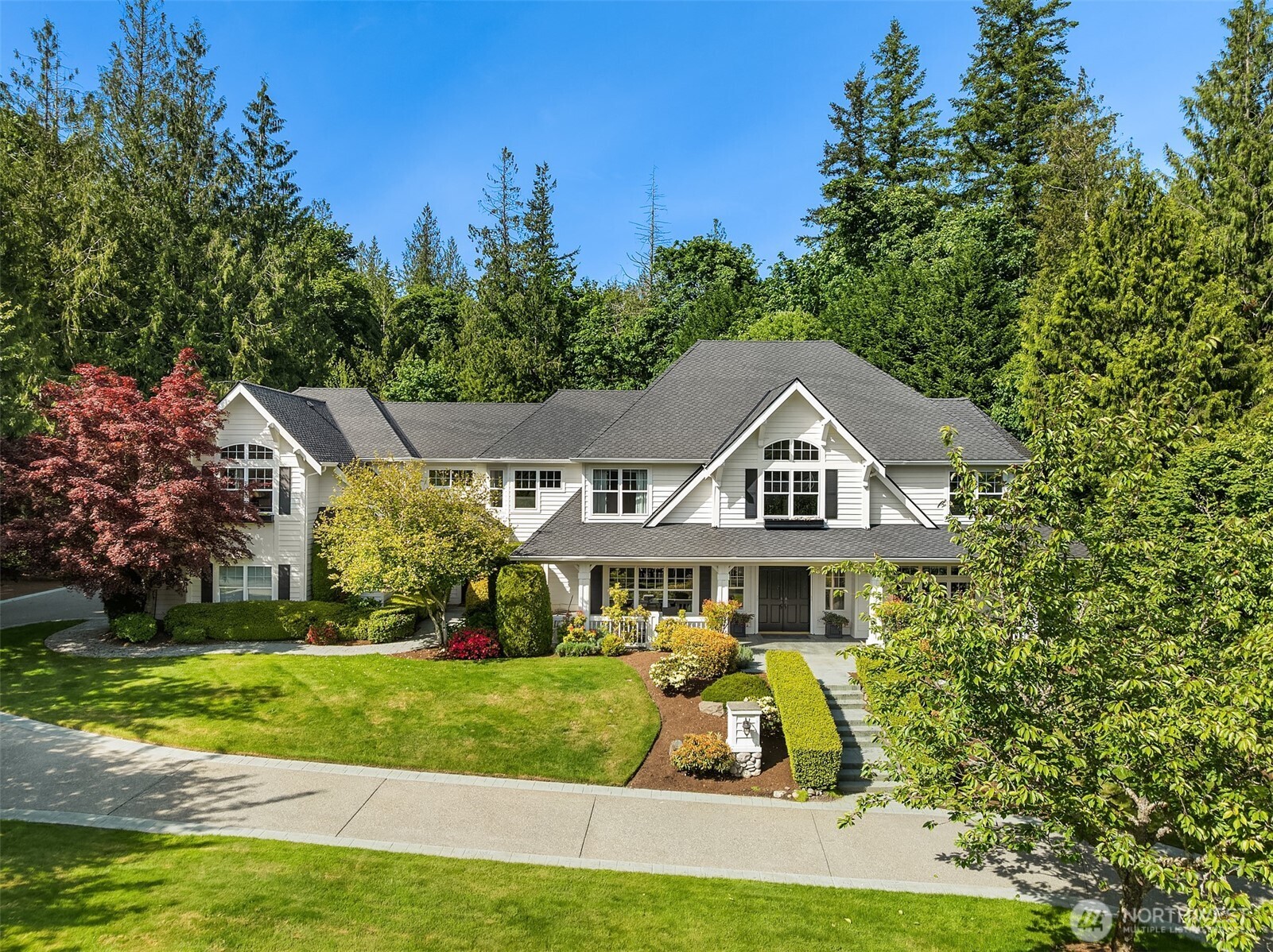 Timeless elegance awaits at Blakely Woods, set on a pristine 1.5-acre estate offering exceptional privacy and beautifully manicured grounds. This remarkable property features resort-style amenities including a sparkling in-ground pool, sport court, putting green, and expansive outdoor spaces designed for both relaxation and recreation. From the moment you enter, the home showcases impeccable craftsmanship and character. A dramatic clerestory entry welcomes you into interiors defined by rich hardwood flooring and extensive use of Calcutta Gold marble throughout. The gourmet kitchen is equipped with a premium Wolf range, an inviting eating nook, and flows seamlessly into a stunning great room highlighted by a floor-to-ceiling fireplace.  The main level also includes a private den, formal living and dining rooms, a ¾ bath, and an additional powder room—perfect for both everyday living and entertaining. Upstairs, the luxurious primary suite offers a serene retreat with fireside seating, abundant natural light, and a spa-inspired five-piece marble bath with high-end finishes. Three additional bedrooms feature beautifully updated bathrooms, while a spacious recreation room and dedicated theater room provide endless opportunities for leisure and entertainment.  This exceptional property truly offers something for everyone—refined living, modern comfort, and resort-like amenities all in one extraordinary home.