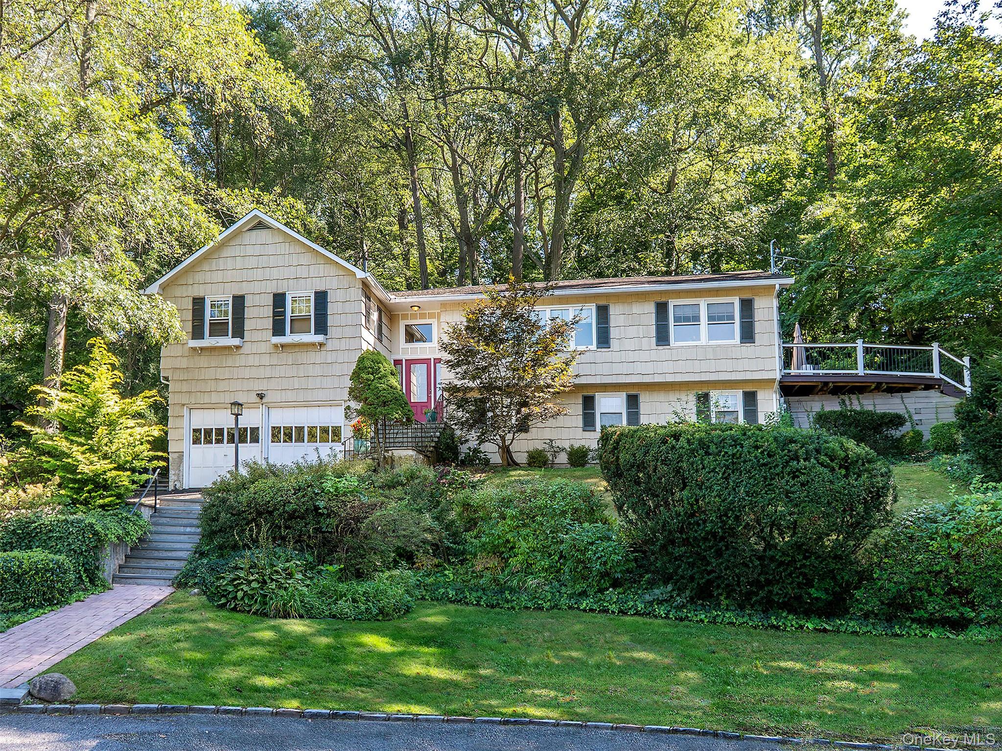 This spacious four-bedroom, three-bath home is nestled on a quiet cul-de-sac and offers beautiful water views. Located in the desirable North Shore School District, it also provides access to all that Sea Cliff has to offer.The home features a finished lower level with additional living space, perfect for privacy and flexibility.Enjoy a deck-ideal for relaxing evenings, taking in stunning sunsets, and enjoying serene partial water views. Inside, you'll find a cozy den with a fireplace, a large dining room, and a bright living room designed for comfortable living and entertaining.The generously sized kitchen flows seamlessly into the dining area and den, with sliders leading out to the deck and yard-perfect for indoor-outdoor living. Close to the beach, this home is ideal for enjoying summer days and watching spectacular July 4th fireworks.