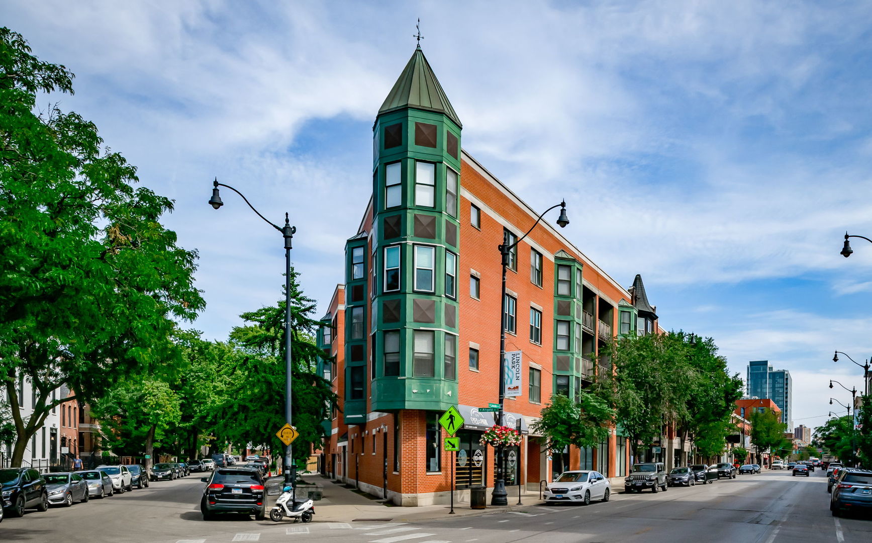 Experience luxury living in this beautiful corner unit that has west, south, & northern exposures, flooding the space with natural light. Nestled in a boutique elevator building in the heart of Lincoln Park, this home is in a prime location. The unit has hardwood floors throughout the whole living area and an abundance of windows that offer stunning treetop views from the covered deck.    The open kitchen has tons of cabinet space, granite countertops, stainless steel appliances, and a stylish backsplash. The spacious living room gives you a multitude of furniture arrangements and is brought together by a cozy fireplace and the separate dining area is surrounded by windows, ensuring a bright and airy atmosphere.    The master bath is a true retreat fully updated with a wall-mounted double vanity, and an LED mirror. The second bedroom offers charm with French doors leading into an elegant turret and wrap-around windows. Additional features include a lovely second full bathroom off the foyer with a tub, in-unit washer and dryer, and window treatments throughout the condo. The unit includes one indoor heated parking space. Convenience is at your doorstep, with everything you need just a short distance away!