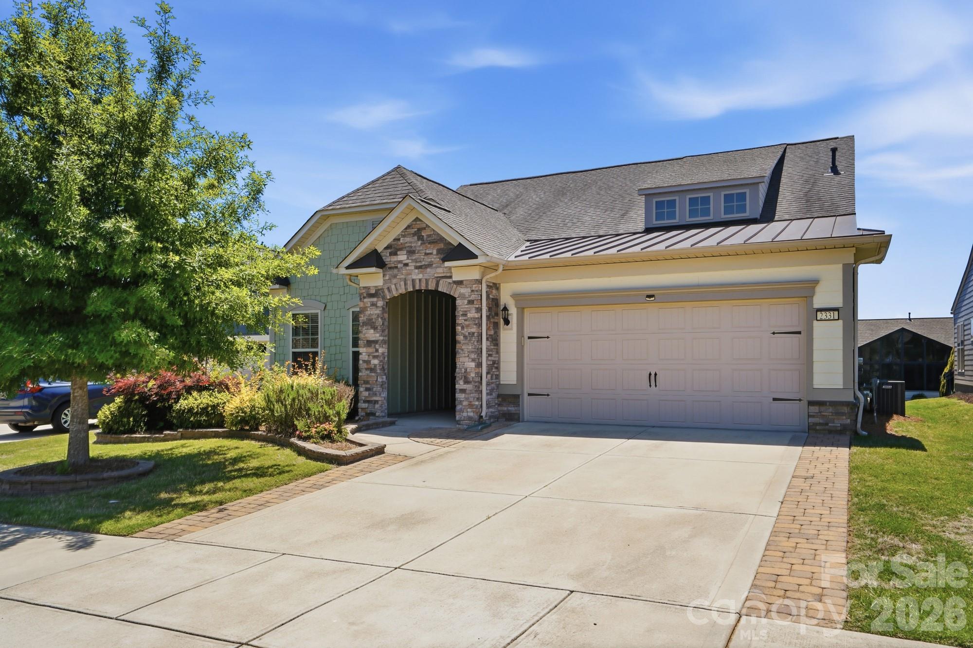 Welcome to Carolina Orchards, one of the area’s premier active adult 55+ communities! This rare 1.5-story Abbeyville plan is loaded with upgrades and designed for easy living and effortless entertaining. Step inside to an open-concept floor plan featuring a stunning floor-to-ceiling stone fireplace and a beautifully appointed kitchen with a large island, gas cooktop, stainless steel appliances, pantry, raised dishwasher, and wall microwave. Just off the oversized garage, you’ll love the convenient drop zone area that adds both function and organization to everyday living. The garage itself is upgraded with a durable polyaspartic floor coating. The elegant primary suite offers a spacious walk-in closet with a custom closet system, dual vanities, and a beautifully tiled shower. Upstairs, the possibilities are endless with a large loft, 4th bedroom, full bath, and an enormous walk-in finished storage area — perfect for guests, hobbies, or additional living space. Enjoy the maintenance-free backyard from the private screened lanai or entertain on the paver patio. Carolina Orchards offers true resort-style living with incredible amenities including a clubhouse, fitness center, tennis, pickleball & bocce courts, indoor & outdoor pools, ballroom, meeting rooms, and countless social activities. This is the lifestyle you’ve been waiting for!
