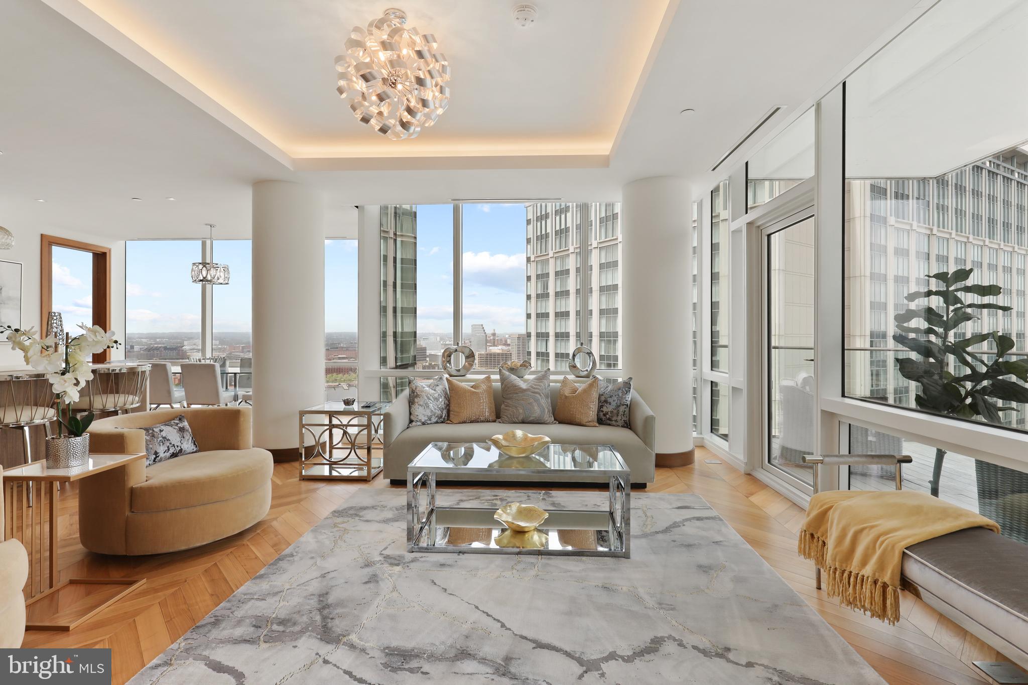 Price Refinement.  Breathtaking Panoramic views of the Inner Harbor from the most Luxurious Building, located in the most coveted Zip Code in Baltimore City, the Four Seasons Private Residences in Harbor East. This 2 Bedroom 2 Bathroom Residence, located on the 24th Floor, features an inviting Open Floor Plan with sprawling Chevron Walnut Wood Floors throughout and floor to ceiling windows in every room to ensure maximum exposure to sunlight and gorgeous views. The Custom gourmet Kitchen is perfectly appointed with Miele appliances and centered around an elegant waterfall marble countertop island that is open to the living space which includes an outdoor Patio where the dramatic views continue. The Primary suite is complete with dressing room and lavish en-suite marble bath w/ large walk-in shower and stand-alone soaking tub. Four Seasons 5-Star Amenities include a Residence Only front entrance and resident only amenities level which encompasses the entire 28th floor and the views continue. This private resident level includes an infinity edged Salt Water indoor heated pool with an open air rooftop Sundeck, a Sauna - complete with its own Harbor Views, fitness room, a large gathering and event space which consists of large dining area, lounge spaces, conference room, billiard area, kitchen space, indoor and outdoor fireplaces, multiple outdoor seating spaces, outdoor grilling area, and an outdoor AstroTurf dog walking space. Four Seasons Private Residences Baltimore, a seamless blend of sophisticated style, lavish amenities, and the exemplary service of the world's preeminent hotelier.