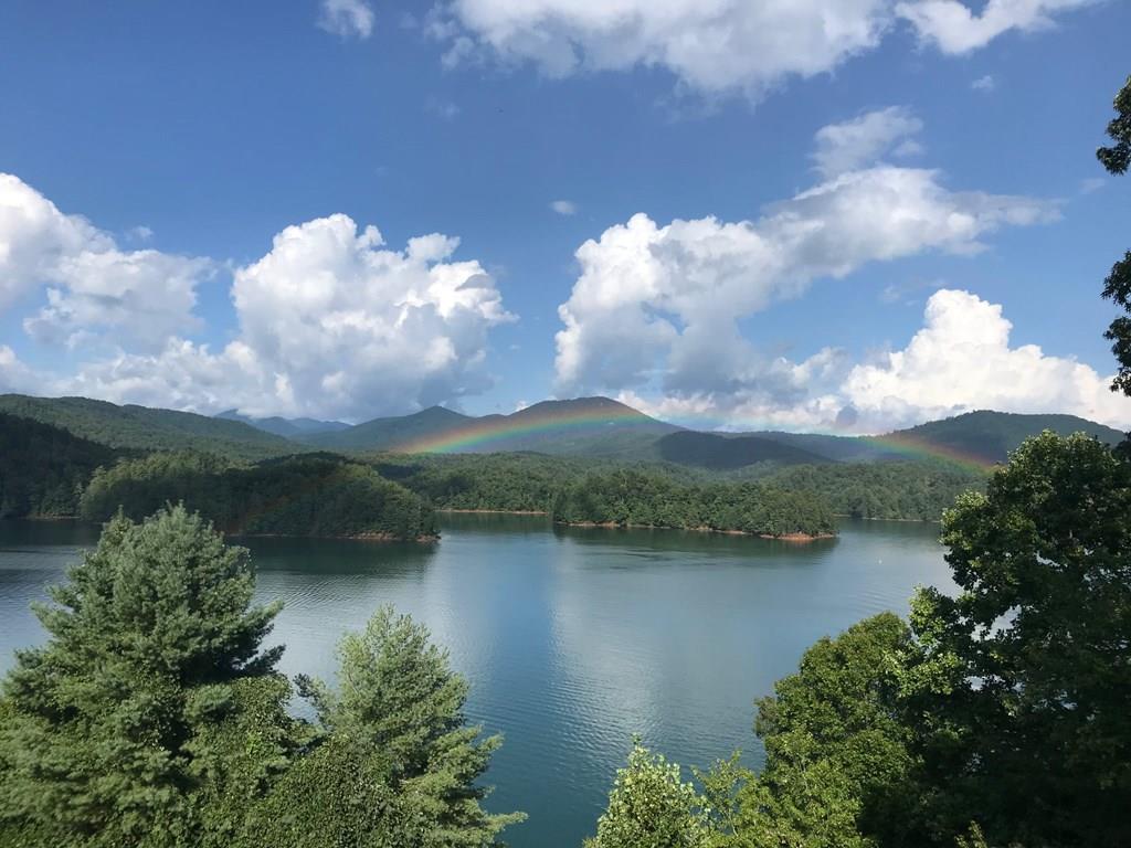 Discover the perfect blend of modern style and low-maintenance living in this beautifully updated 3 bedroom, 2 bath lake-view condo located inside one of the area's most desirable gated communities with fully paved roads along with a community pool, tennis courts, pavilion, and playground area!. This sleek, move-in ready unit offers an open and airy layout with abundant natural light and tasteful contemporary finishes throughout. Step inside to find a stunning modern kitchen, upgraded flooring, stylish fixtures, and a seamless flow into the living and dining areas—perfect for both relaxing and entertaining. Large windows frame peaceful views of the lake, creating a calm and luxurious atmosphere year-round. The spacious primary suite features a well-appointed bath and generous closet space, while two additional bedrooms provide flexibility for guests, an office, or family needs. Enjoy your morning coffee or evening unwind on the private balcony taking in the water and mountain scenery. Located in a secure gated community, residents benefit from low-maintenance living, paved roads, beautiful surroundings, and convenient access to nearby shopping, dining, outdoor recreation, and more. Whether you're seeking a full-time residence, vacation home, or investment property, this modern condo offers the best of comfort, convenience, and lake-view living.