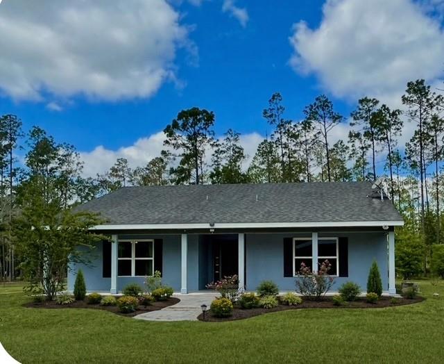 One or more photo(s) has been virtually staged. Looking for privacy, peace, and quiet? This beautiful 20-acre property—featuring a custom-designed solid block  3-bedroom, 3.5-bath home—offers the serenity and space you’ve been dreaming of.  Step inside to a fantastic, efficient floor plan with no wasted space. The open-concept Great Room flows seamlessly into the spacious kitchen, creating the perfect setting for entertaining or gathering with family. The kitchen features solid wood 42-inch cabinetry, a large island, and abundant counter space. A large laundry/utility room is located beside the kitchen for storage and wash.  Expansive windows throughout keep the home bright while providing sweeping views of your private acreage. The split bedroom layout includes a generous Primary Suite with a walk-in closet and an en suite bathroom complete with dual sinks and an oversized walk-in shower. Each of the two large secondary bedrooms also offers its own private full bath and ample closet space—an ideal setup for multi-generational living or long-term guests. A convenient guest half bath is located off the main living area. French doors open to the impressive 44' x 15' screened lanai, spanning the entire back of the home. Enjoy peaceful mornings and evenings watching native wildlife—deer, hawks, and more—right from your own backyard. The property is a rare full 20-acre, high-and-dry parcel. It includes a 1-acre fenced pen currently used for cows, plus three pole barns—one 60' x 30' and two 30' x 15'—providing exceptional versatility. Timber, yellow pine planted offers beautiful private  forest and agricultural tax advantage or ready to be harvested for value if cut to clear more of the property. There is a small pond on the property.  Bring your horses and enjoy nearby riding trails at Lake Heart Conservation Area. Location is a dream for equestrians:• Heart Island Conservation with 5 miles of horseback riding trails is located at the end of Winning Wood Trail• Ocala National Forest with over 100 miles of looping horse trails is 30-minutes • Spring Garden Ranch, North America’s largest Standardbred training facility, is only 4 miles away• Rocking Horse Stables, a USEA-recognized event venue for dressage, jumping, and cross-country, is 28 miles away• The world-renowned Ocala World Equestrian Center is just 60 miles from the propertyAll of this is conveniently located minutes from DeLeon Springs State Park, offering swimming, birdwatching, and dining at the historic Sugar Mill Pancake House. You’re also just 32 miles from Daytona Beach and a short drive to charming downtown DeLand, known for its Old Florida character with modern amenities. Daytona Beach International Airport 29 miles. A This exceptional property combines privacy, nature, and true Florida living—a rare opportunity you won’t want to miss.