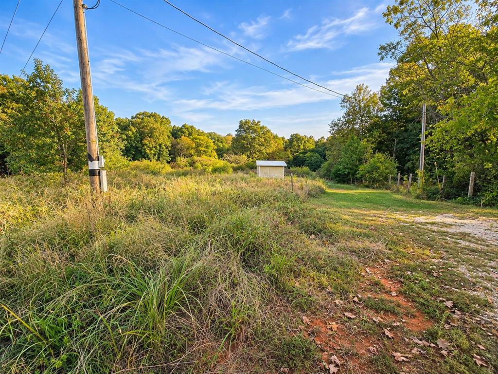 This beautiful 1.69 acres has a foundation for a trailer home and access to utilities. It has fruit trees and a small office building anchored to part of the trailer foundation. It is really a beautiful place.