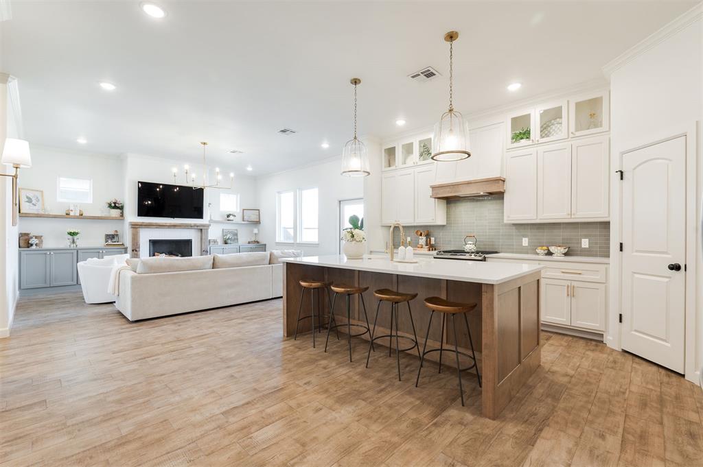 Fall in love with this classic beauty in east Edmond’s Covell Valley! Built by Silver Stone Homes in 2023, this home is truly better than new - featuring timeless finishes and thoughtful upgrades at every turn. The light brick, arched entry, awnings & carriage lights make for the most stately of arrivals. Light & bright with a style guaranteed to leave an impression- this open concept layout that allows for easy entertaining. Brilliant light fixtures, exposed wood beams - it’s all in the details. The kitchen is simply stunning - stained wood island, quartz counter tops, stainless appliances, a coffee bar & pantry. Herringbone flooring design and accent wall create a regal dining room fit for a sprawling table. The living room is both comfortable and dreamy- with fireplace & built-ins - a beautiful place to unwind. The roomy master suite offers plenty of space in the bedroom & double vanity, floating tub, shower & an incredible walk-in closet. Two secondary bedrooms are found at the west end of the home with another full bathroom in between. At the front of the home is an office/study that could also function perfectly as a fourth bedroom or playroom. Enjoy the fresh air on your spacious covered patio. Additional highlights include custom window treatments, sprinkler system, gutters, Jasco eternity lighting on the exterior & stone paver walkway on the west side of the property. This active & exciting neighborhood offers amenities including swimming pool, club house & park! The most convenient location - you’ll love the peace & quiet that east Edmond offers, all while being just a mile from I-35 & the vibrant entertainment district right on Covell - with new restaurants, grocery stores & movie theater a few minutes away! A high quality home with the most remarkable and design- come see it soon!