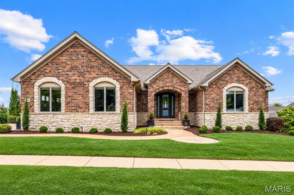 Sophisticated full-brick ranch home with over 4,300 sf of living space enhanced by maple hardwoods, dimensional ceilings, contemporary lighting & energy efficient systems. Impressive entry foyer leads to private study with custom built-ins and stunning great room highlighted by stacked stone accent wall with fireplace. Designer kitchen featuring quartz countertops, custom ash cabinetry, professional quality appliances, 10’ center island & butler’s pantry adjoins dining room with sliding glass doors that open to screened porch. Spacious primary bedroom suite with 2 walk-in closets & luxury bath with jetted tub offers an appealing retreat. A 2nd ensuite bedroom completes the main floor living quarters. Lower Level entertainment space includes recreation room with wet bar, game room, workout room, guest suite & 4th bedroom. Situated on a premium cul-de-sac lot with deck, covered & open patios & oversized 3-car garage. Premier gated community with walking trails, ponds, fountain & waterfall.