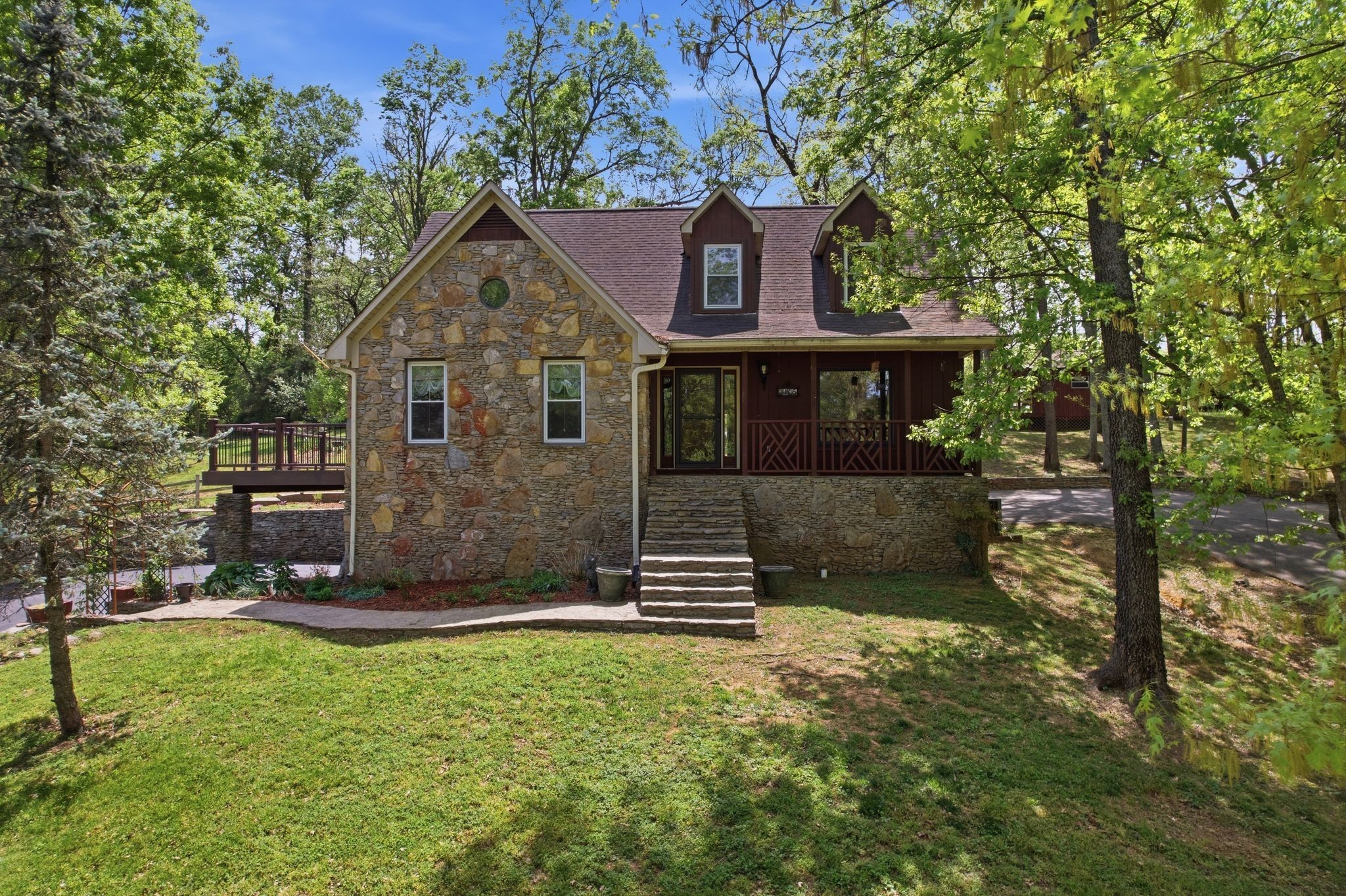 Charming rustic retreat featuring natural stone exterior paired with western cedar accents. Nestled among mature trees on an .69 acre lot, the home has a timeless, lodge-inspired feel that blends seamlessly with its wooded setting. Offering 3 bedrooms 3 1/2 baths, basement mother-in-law or teen suite with new flooring, Amish hand-cut oak flooring, remodeled kitchen and bathrooms, new HVAC units, new windows. Outside you'll find a puttering/garden shed, 2 driveways, fenced backyard, 3 water features, trex decking, hand picked stone walkways. Located only 1/2 mile from Maury Regional Hospital, shopping and dining ! NO HOA!
