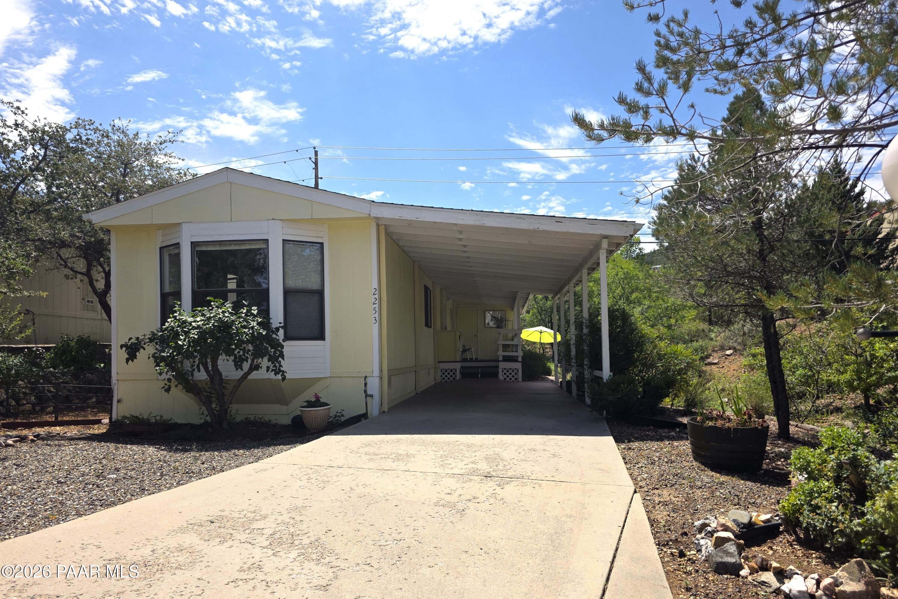 Cute cottage style home in Prescott Canyon Estates. Open floor plan, 2 Bedroom, 1 remodeled Bathroom, A/C, carport, covered deck, storage room. Beautiful setting with private back area and neighboring seasonal creek. Close to the clubhouse, shopping and restaurants. Perfect for your vacation getaway or year round living. Community clubhouse offers an indoor pool, hot tub, game room, kitchen and tennis. Prescott Canyon Estates is a 55+ subdivision .
