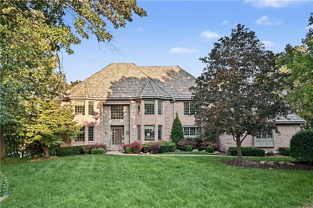 Tucked at the end of a quiet cul-de-sac, this extraordinary 1.5-acre property offers the rare feeling of a private retreat—surrounded by mature trees, peaceful water views, and a beautiful park-like setting. Here, nature is part of everyday life, with room to unwind, entertain, and enjoy the outdoors in every season. It’s a remarkable setting for lake living in the sought-after, gated community of Loch Lloyd. This impressive all brick home offers more than 7,000 square feet, with 4 bedrooms, 4 full baths, 2 half baths, and a 3-car garage. A grand entry and sweeping staircase create a memorable welcome, while expansive windows and generously proportioned rooms invite you to imagine the possibilities. A private office, spacious kitchen, oversized laundry room, inviting primary suite, and walk-out lower level provide a wonderful foundation for comfortable living and entertaining. With its scale, character, and versatile spaces, this home offers an exceptional opportunity to personalize and create something truly your own. Loch Lloyd is more than a community—it’s a distinctive lifestyle. Enjoy an amazing golf course, country club dining, tennis and pickleball courts, a swimming pool, walking trails, social activities, and more. With a spectacular lot, a substantial home ready for its next chapter, and a wealth of community amenities, this is a rare opportunity to make your vision a reality and experience the best of Loch Lloyd living.