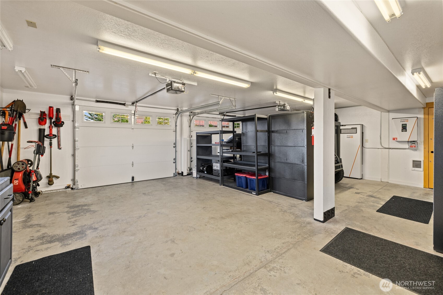 Heated two-car garage with additional storage space and solar battery backup system.