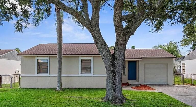 Updated, move-in ready 3 bedroom, 2 bathroom, 1 car garage home just minutes to downtown New Port Richey! BRAND NEW ROOF (2026) Newer AC (2022). No HOA, no CDD fees. Fresh exterior & interior paint (2025). Features tile flooring all throughout. Low-maintenance and ready for its new owners. Updated kitchen with newer cabinetry, double sink, comes with refrigerator, dishwasher, range, and microwave. Spacious primary suite offers a walk-in closet & updated en-suite bathroom. Two additional generously sized bedrooms share guest bathroom. Screened in porch overlooking the fully fenced backyard, perfect for entertaining, pets, or simply relaxing. Washer & dryer included with the home. Located in a desirable golf cart-friendly community, head downtown New Port Richey to enjoy restaurants, breweries, boutique shopping, Sims Park, waterfront events, year-round entertainment. Conveniently located near schools, shopping, medical facilities, beaches, major roadways. It's the perfect blend of comfort, convenience, and lifestyle. First-time homebuyer, downsizing or searching for an investment, this home checks all the boxes!