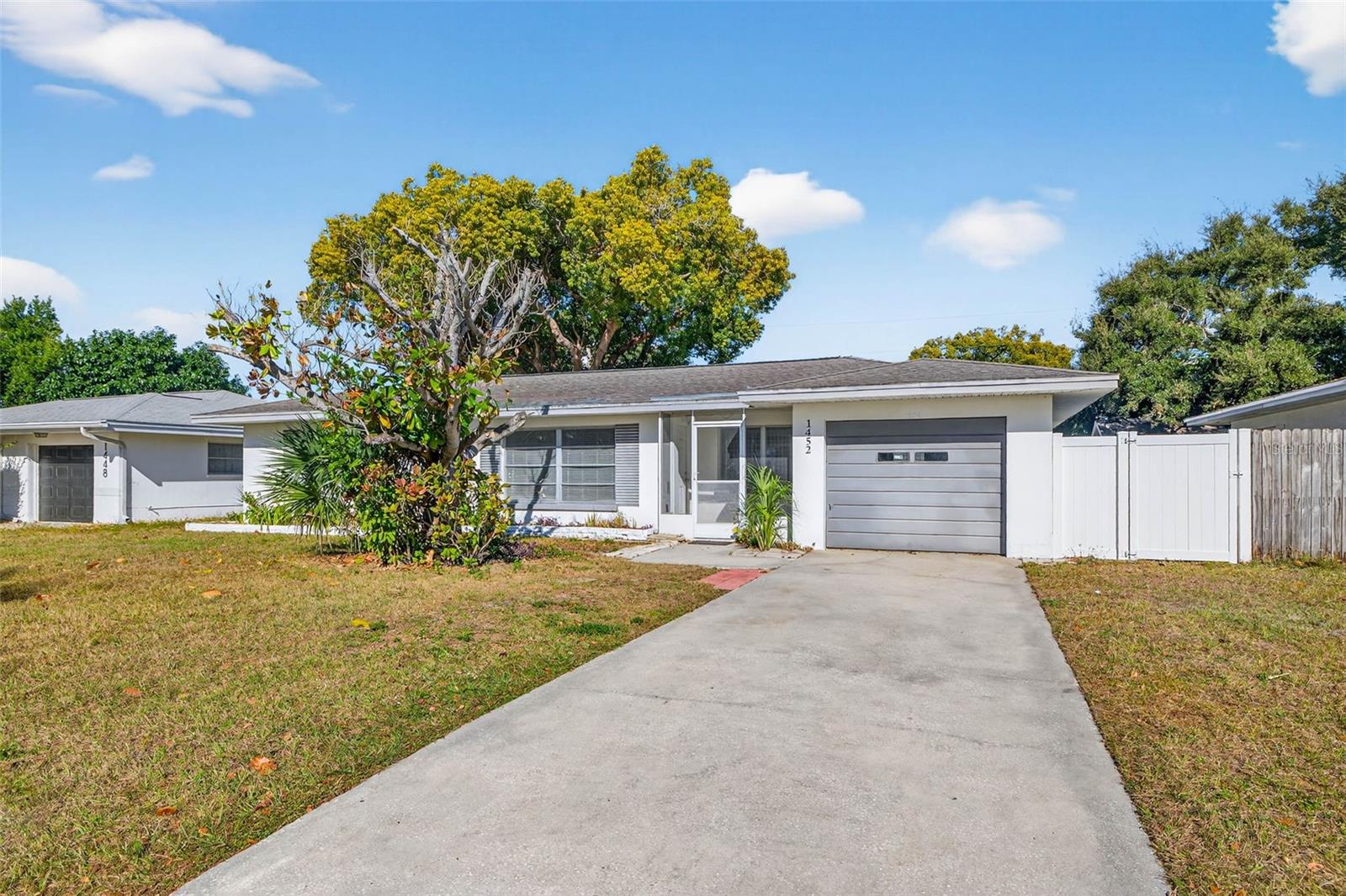 Nestled in unincorporated Pinellas County, this solid block construction home presents a versatile and inviting opportunity in sunny Clearwater. The residence offers 2 bedrooms and 1.5 bathrooms, with a 1 car garage for safe covered parking and additional storage. The home features classic terrazzo flooring throughout that adds both timeless character and easy, low-maintenance living. Inside, you’ll love the spacious living room filled with natural light. It’s an inviting spot for movie nights, casual get-togethers, or simply relaxing after a long day. The enclosed Florida Room expands the living space and captures the essence of Florida living—perfect for relaxing, entertaining, or enjoying the space year-round. Conveniently located approximately 15 minutes from Clearwater Beach and close to shopping, dining, and major roadways, this property combines location, flexibility, and classic Florida charm. There’s also ample space to park an RV or boat, and with no HOA, no deed restrictions, and no required flood insurance, you can truly make this home your own. With its unincorporated setting, the home offers future owners the opportunity to enjoy it as a personal residence or explore investment potential.
