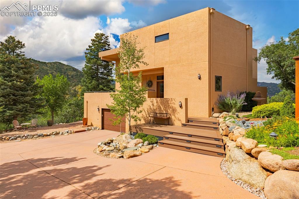 *Take a look at the video tour hyperlink of this masterpiece with Unmatched Mountain View’s. Experience the pinnacle of Colorado living in this custom home among nature with views from every side of the house. Located in Crystal Hills with no HOA, it’s perfectly positioned to capture the best views in town. Overlooking the majestic Manitou Springs mountains, Garden of the Gods, and Red Rock Open Space, this architectural gem offers panoramic vistas from nearly every window.The home was crafted with meticulous attention to maximizing both mountain and city views, bringing the outdoors in with its seamless integration of light, space, and landscape.Featuring 5 bedrooms and 3.5 bathrooms. This home boasts a main living room with soaring 17-foot ceilings, topped with an impressive great room reaching over 20 feet, flooding the interior with natural light from the clerestory windows. Step outside and immerse yourself in spa-like outdoor living spaces, complete with lush, serene landscaping, a tranquil water feature, and a level of privacy rarely found so close to town. Enjoy Colorado’s beauty from a deck on every side of the home, constructed with premium Redwood and Fiberon Composite decking, designed for low maintenance and timeless appeal.Additional highlights include:The air conditioning is an added comfortable benefit, the heat pump provides both heating and air conditioning. Clean, quiet hot water heating system with multiple thermostat zones for personalized comfort.High-end Marvin windows and deck doors, framing breathtaking views of Intemann Trail, Ring the Peak, Garden of the Gods, and Section 16 trail.Trail access within 300 yards, connecting you directly to the outdoor adventures of Red Rock Open Space.This is more than a home—it’s a sanctuary where nature, architecture, and luxury meet.