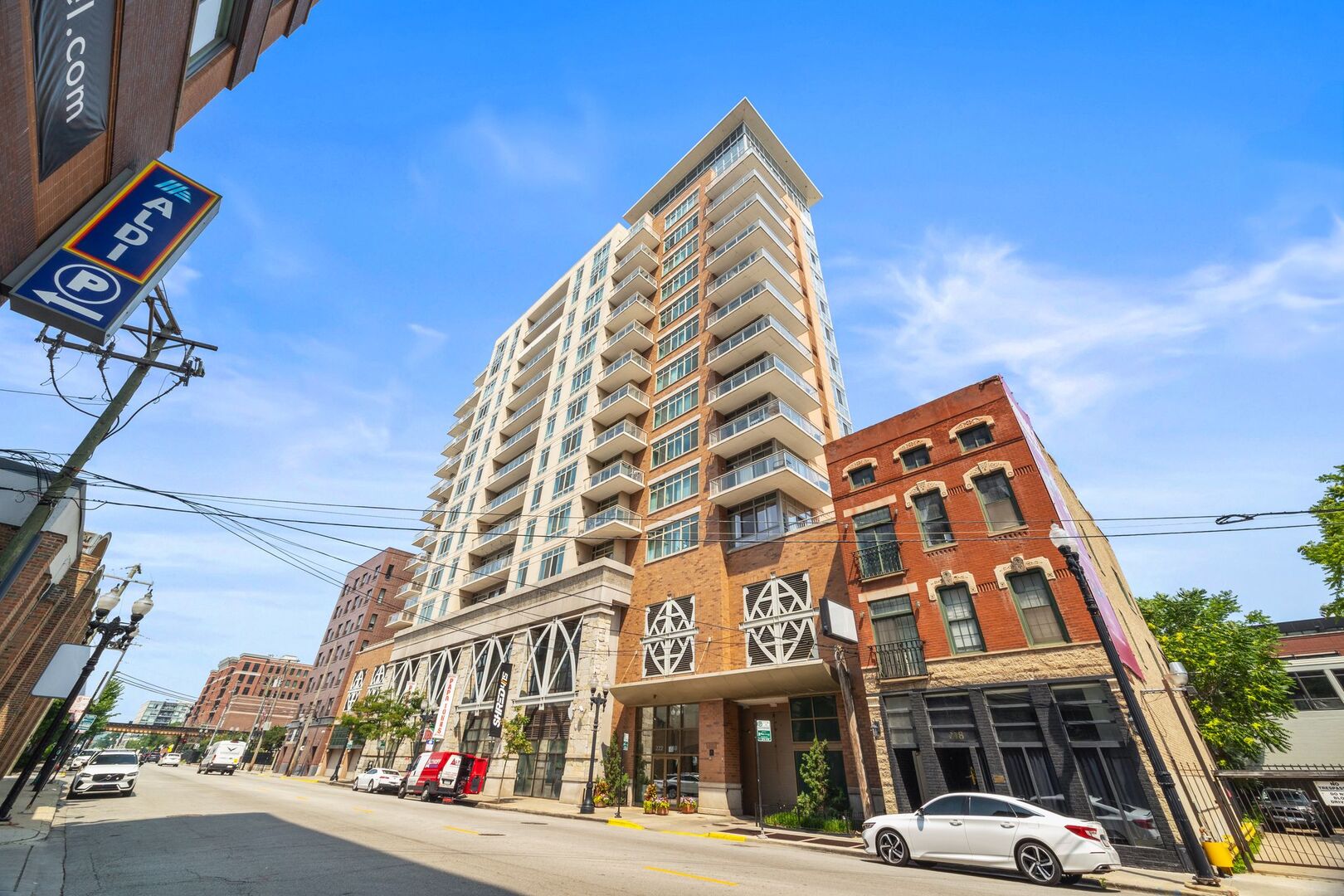 Spacious Corner 2 bedroom + den 2 bath condo in Old Town. This south facing, high-floor unit has skyline views with an open floorplan in a full amenity building.  Tiger bamboo floor thru out and natural hickory cabinets with natural stone in kitchen & baths.  Den features custom murphy bed. Expansive primary suite with closet organizers. Wrap around balcony with panoramic south & west views.  In unit laundry. Building features include: rooftop deck, penthouse level gym, and doorperson.  1 deeded garage parking space included in price and 1 additional available for $25k.