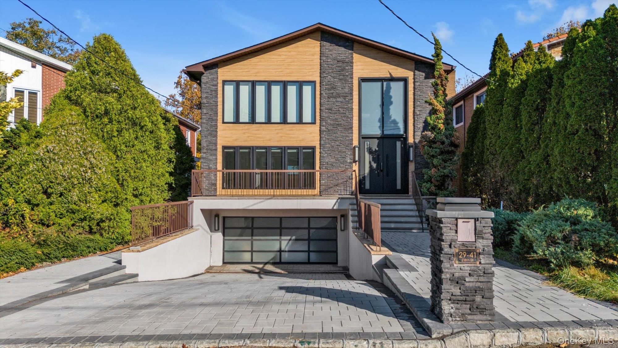 Experience coastal luxury at its finest in this 2025 newly renovated modern masterpiece, where panoramic ocean views meet exquisite craftsmanship. The main level features an open-concept layout with floor-to-ceiling windows framing endless sea vistas. A chef’s dream kitchen showcases custom inset cabinetry, 3” mitered quartz countertops, full-height quartz backsplash, and a stunning quartz breakfast island with seating for seven. Premium appliances by Wolf, Subzero, and Cove ensure a top-tier culinary experience, with plumbing ready for a steam oven. The living and dining areas flow seamlessly onto the ocean-facing deck and pool, perfect for entertaining or quiet sunset moments. Upstairs, the primary suite offers a full wall of glass overlooking the bay, creating a serene, resort-like retreat. The spa-inspired bathroom includes a soaking tub, marble walls, and dual vanities. The lower level features a recreation lounge, private office with custom cabinetry and quartz surfaces, and direct access to the pool terrace. Unique architectural details include a floating steel staircase with solid 3” walnut treads, a glass-wall garage with car lift, and an 18-foot electro-chromatic glass front door that turns opaque at the touch of a button. A rare combination of design, technology, and breathtaking views—this home redefines coastal living.