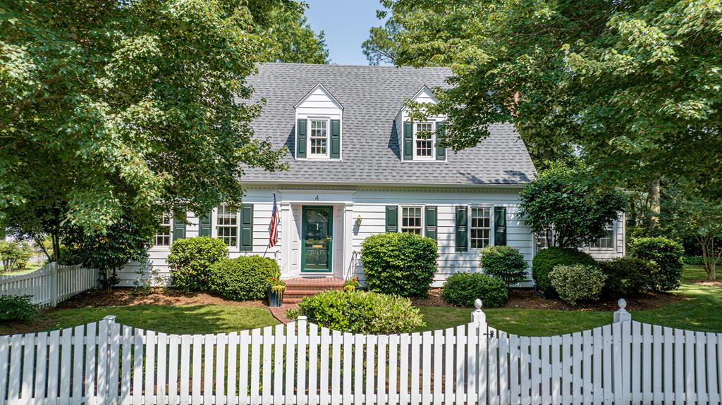 4 Onancock Street, a picture-perfect 4-bedroom, 3-full bath Cape nestled behind a white picket fence. This beautifully maintained home pairs timeless character with thoughtful modern updates. Inside, find a gourmet kitchen with custom cabinetry, honed granite countertops, a professional-grade appliances, and center island. Floor plan features 1 level living if preferred. Step outside to a fenced yard with mature trees and manicured landscaping — a peaceful retreat perfect for relaxing, gardening, or hosting gatherings. The detached 2-car garage and a separate auxiliary building offer incredible versatility: use it as a workshop, creative studio or with town approval possible guest cottage. Spacious lot - a great perk for in town living. Conveniently located to town amenities and medical.