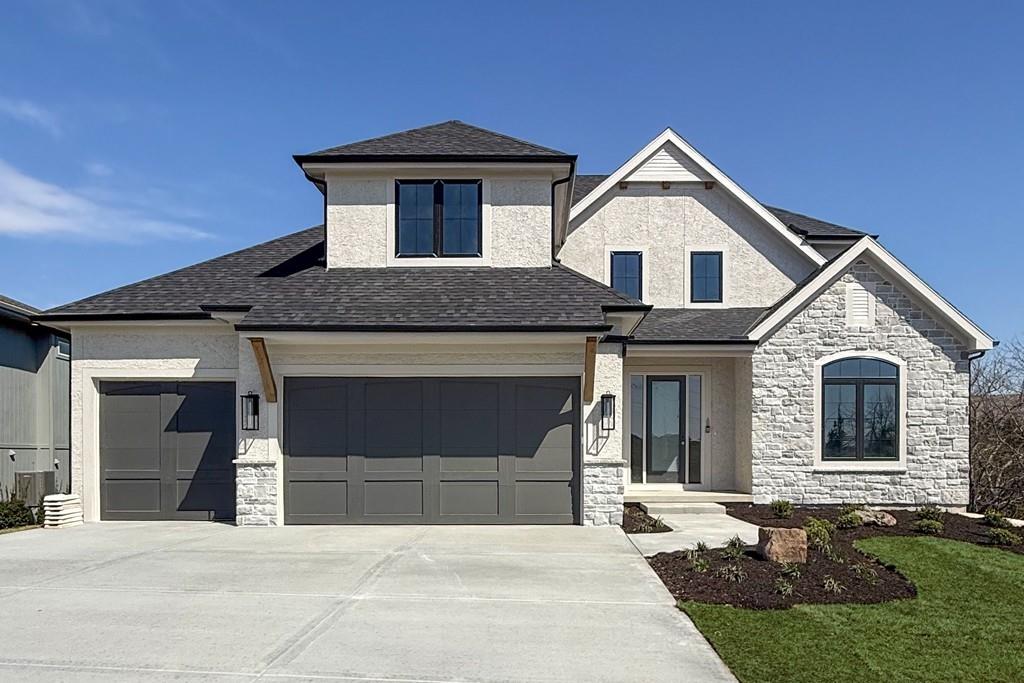 Hilmann Home Building has done it again! Their newest Santa Barbara plan is here, and it is amazing! This 1.5 story plan features a gorgeous main floor with tall, vaulted ceilings, floor to ceiling fireplace, book cased with custom built-ins on either side, a large gourmet style kitchen with a butler pantry, an oversized dining area that offers direct access to the covered deck overlooking the trees in back. The large main floor Primary Suite features its own access to the covered deck, a vaulted ceiling and a luxurious bathroom that includes dual vanities, a relaxing soaker tub, and dual closet areas. The second main floor bedroom, located just off the entry, would make an excellent guest suite or a large home office. Step upstairs to find the large loft area with second fireplace, a perfect hangout area for the family. Bedrooms 3, 4, and 5 are also upstairs and they each feature their own bathrooms and walk-in closets. The huge unfinished lower level provides great storage along with unlimited possibilities for a future lower-level finish. The walkout lot backs to trees and offers a flat, activity-friendly backyard. Located in the desirable community of Cedar Creek - Valley Ridge. Amenities include a 65 acre private, fishing, kayaking and canoeing lake offering some of the best fishing in Johnson County. Three resort style swimming pools, a 2-story clubhouse that includes an indoor basketball court, workout facility, outdoor tennis courts, pickleball courts, sand volleyball, and miles of walking trails. Come see why so many homeowners have made the decision to call the Community of Cedar Creek home.