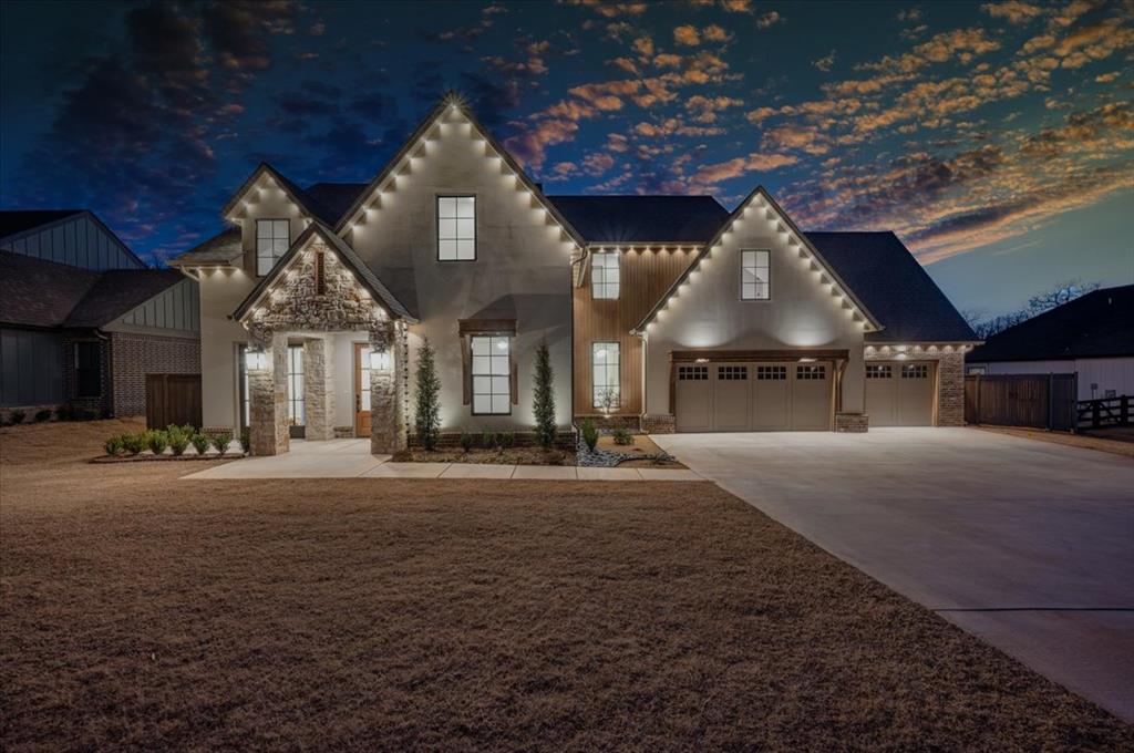 From the moment you arrive, this striking home stands out with its creamy stucco and stone timber accents, and manicured landscaping. Inside, vaulted ceilings crown the light-filled living, dining, and kitchen spaces, where beautiful flooring, French doors, and walls of windows frame serene tree views. The chef’s kitchen is the heart of the home, featuring a large marble-clad island, professional gas range, double ovens, side-by-side built-in refrigerator and freezer, custom cabinetry to the ceiling, and open shelving. A scullery adds extra prep space with sink, dishwasher, built-in microwave, and abundant natural light, while nearby built-in desk and mudroom storage keep daily life organized. The private primary suite feels like a spa retreat with a freestanding soaking tub beneath a picture window, oversized subway-tile shower, dual vanities with stone counters, and a walk-in closet with generous shelving and drawers. Secondary bedrooms are well-sized with ample closets and are served by stylish bathrooms with quartz vanities and tile surrounds. Since purchase, the owner has added approximately 500 square feet upstairs, creating a true additional bedroom and large bonus room, along with a dedicated office area, significantly enhancing the home’s functionality. Prior to this expansion, the home appraised at $288.64 per sqft, reflecting the quality of construction and added value. Outdoor living is equally impressive with a covered patio and expansive tree-lined yard. The owner has added a wood privacy fence, iron fence along the back, and a retaining wall running from the west side across the rear of the yard, enhancing both aesthetics and usability while backing to a wooded lot that extends past the creek. Additional upgrades include a water softener and filtration system, along with permanent Govee lights. Located in a small gated community within Edmond schools, this home offers privacy and natural beauty. Color of cabinets and doors are beige.