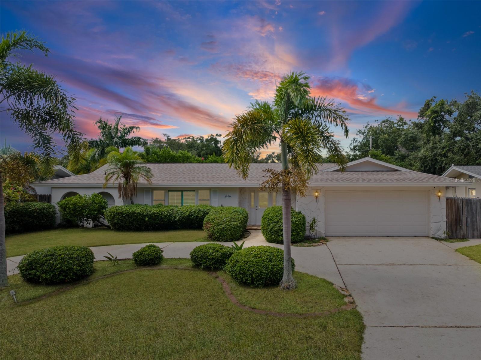 Virtually Staged. Beach days, boating days and a pool waiting when you get home. Located in Harbor Hills, adjacent to Harbor Bluffs and surrounded by multimillion dollar waterfront properties, 1570 High Bluff Dr W, Largo, FL 33770 puts you minutes from Belleair Bluffs, Belleair, beaches, golf, parks, local dining and shopping.This single story, 4 bedroom, 2 bathroom pool home offers approximately 2,023 square feet, a split bedroom layout and a 2 car garage. Updates include a roof replaced in 2025, AC replaced in 2023, impact windows, a water filtration system, newer pool equipment, newer ductwork and fresh paint inside and out. Located in Flood Zone X; the lowest risk zone.  According to the seller, the home has not experienced any flooding.The spacious kitchen gives you room to actually cook and entertain, with generous cabinetry and counter space, a center island with cooktop, a built in oven and microwave, stainless steel appliances and windows overlooking the pool. From morning coffee in the breakfast nook to Sunday brunch or dinner in the separate dining area, there is room to gather without crowding the cook.The primary suite sits apart from the other three bedrooms and includes a walk in closet, private bathroom and direct access to the screened pool area. Additional bedrooms offer flexibility for guests, working from home or hobbies. Inside laundry, plantation shutters and flooring without carpet add everyday convenience.Outside, the expansive screened pool area is ready for afternoons in the water and evenings around the table. There is plenty of room for lounge chairs, outdoor dining and friends who stay a little longer. Mature landscaping, a fenced backyard and a curved driveway complete the setting.Indian Rocks Beach’s 27th Avenue public access is approximately 3.8 driving miles away, with two convenient ways to reach Indian Rocks Beach via Belleair Causeway or Walsingham Road and the Indian Rocks Beach Bridge. Prefer to bike to the beach? The bicycle route to the 27th Avenue Beach access is less than 4 miles away.Indian Rocks Beach has that relaxed beach town feel, with sandy shoreline, neighborhood beach accesses, local restaurants and sunsets worth making time for. Spend the afternoon on the sand, then meet friends for dinner. Whatever your taste buds are craving, there’s a local spot for you.Keep your boating plans close, too. Belleair Causeway Boat Ramp is less than 2 driving miles away. Pelican Golf Club is less than 3 driving miles away, Belleair Country Club and Splash Harbour Water Park are less than 4 driving miles away. Both golf Course clubs offer opportunities to explore private membership.Harbor Hills is an established, deed restricted neighborhood in unincorporated Pinellas County with a Largo mailing address. Bring your beach chairs, bicycles and boating plans. Spend your weekends enjoying the reason you live in Florida.