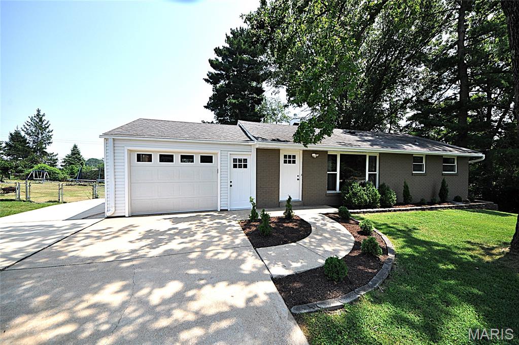 WELCOME HOME to this move-in ready, UPDATED 4 bedroom, 2 bath ranch home in the heart of Rockwood School District on prime level lot backing to trees, common ground and park. Interior displays NEW: HVAC, interior/exterior doors, lighting, remodeled kitchen & baths AND MORE! Main floor showcases refinished and stained original wood flooring. Living room w/double closet space for extra storage & TONS of natural light. Eat in kitchen w/stainless steel appliances including refrigerator, new dishwasher, custom cabinetry & modern tile backsplash. 3 spacious bedrooms & fully remodeled bathroom on main level. Partially finished walk out lower level includes new luxury vinyl plank flooring & lots of natural light throughout. Sprawling recreation/family room w/atrium door out to patio & picture window overlooking backyard. 4th bedroom w/wall of closets & large full bath in lower level. Exterior shines with fresh landscaping, covered porch, newer architectural shingle roof, oversized garage. Fenced in, level backyard includes double wide gated entry and has NEW oversized deck looking to shed & trees/park. Walk to the park on the adjoining lot or quick drive to EVERYTHING including shops, restaurants, schools, etc.