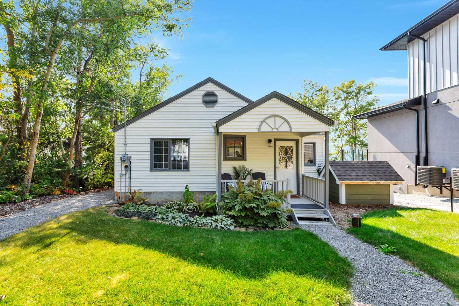 Welcome to your dream lakefront getaway! Nestled on the sunny side of Sylvan Lake, this beautifully renovated cabin sits on a level 50x203’ lot with 50 feet of pristine shoreline and stunning southwest-facing views. With full riparian rights and some of the best sunset views on the lake, this is a rare opportunity to enjoy both privacy and prime water access year-round.  The cozy yet spacious 1,044 sqft cabin features 3 bedrooms and 1 full bath, all recently updated with stylish finishes. Step inside and fall in love with the warmth of the wood panel ceilings, corner wood-burning fireplace, and the perfect blend of rustic charm and modern convenience. Recent upgrades include a brand new kitchen, new flooring, updated lighting, and a refreshed bathroom with new shower, vanity, and toilet. The home is also equipped with new appliances (fridge, stove, dishwasher, washer, and dryer), on-demand hot water, a new furnace, new shingles, and eavestroughs — making it fully move-in ready and fully winterized for year-round enjoyment. Modern touches include the ability to charge an electric vehicle, perfect for today’s environmentally conscious homeowner. Outside, the home continues to impress with extensive landscaping, RV parking pad and a large deck perfect for morning coffees or evening wine overlooking the lake. Whether you're swimming, boating, or relaxing by the fire, this property delivers the ultimate lake life experience.