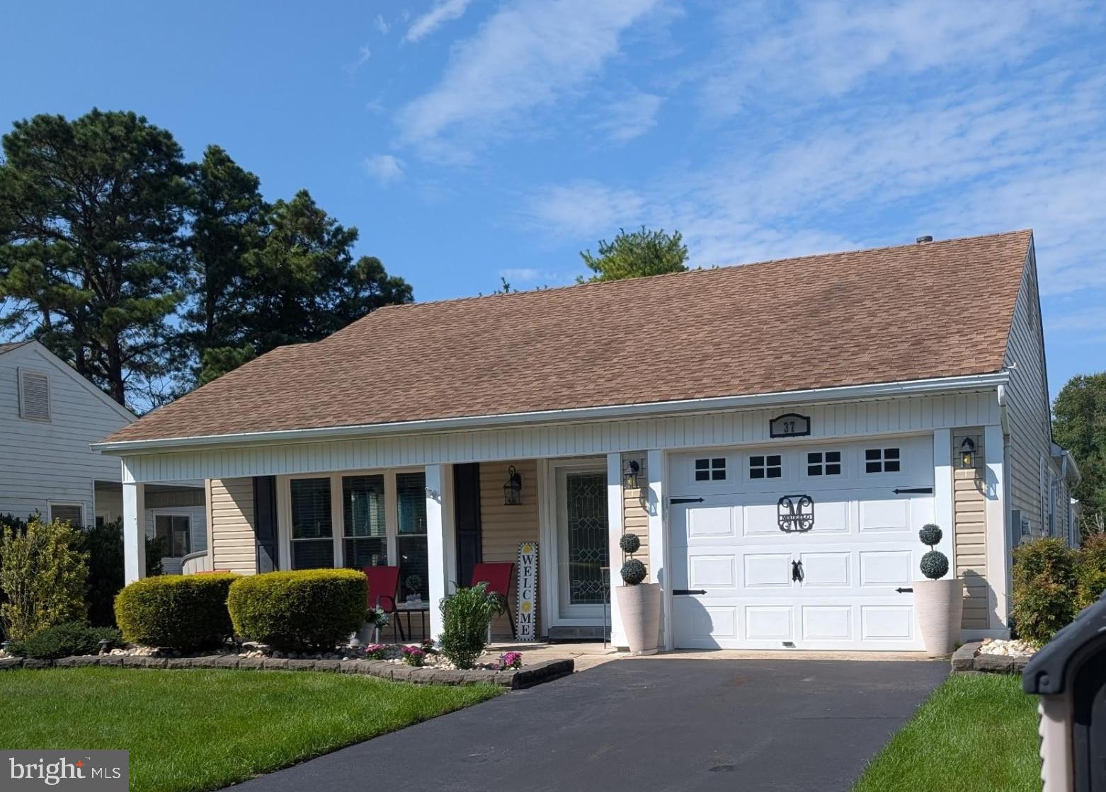 Nestled in the desirable, active adult 55+ community of Leisuretowne sits 37 Stratford  Rd.  Don't miss out on this spacious 1700+ square foot gas Greenport model.  The home has been meticulously cared for with 2 bedrooms and 2 full bathrooms. Pulling into the driveway you are greeted with a nicely manicured yard and beautiful mature landscaping.  When you step inside you immediately notice the gorgeous oak hardwood floors through the main living area.  Plenty of natural lighting streams in to highlight the neutral décor. There is a large living room ideal for relaxation and entertainment, along with a formal dining room perfect for hosting meals or gathering, The open kitchen boast a separate breakfast area for casual dining which flows into a sitting room with a wood burning fireplace. The primary bedroom has been nicely designed featuring a walk in closet, ensuite bathroom with a step in shower.  In Leisuretowne you will appreciate the low HOA fees and a variety of community amenities including 2 pools, clubhouses, shuffle board, tennis courts and many social clubs.
