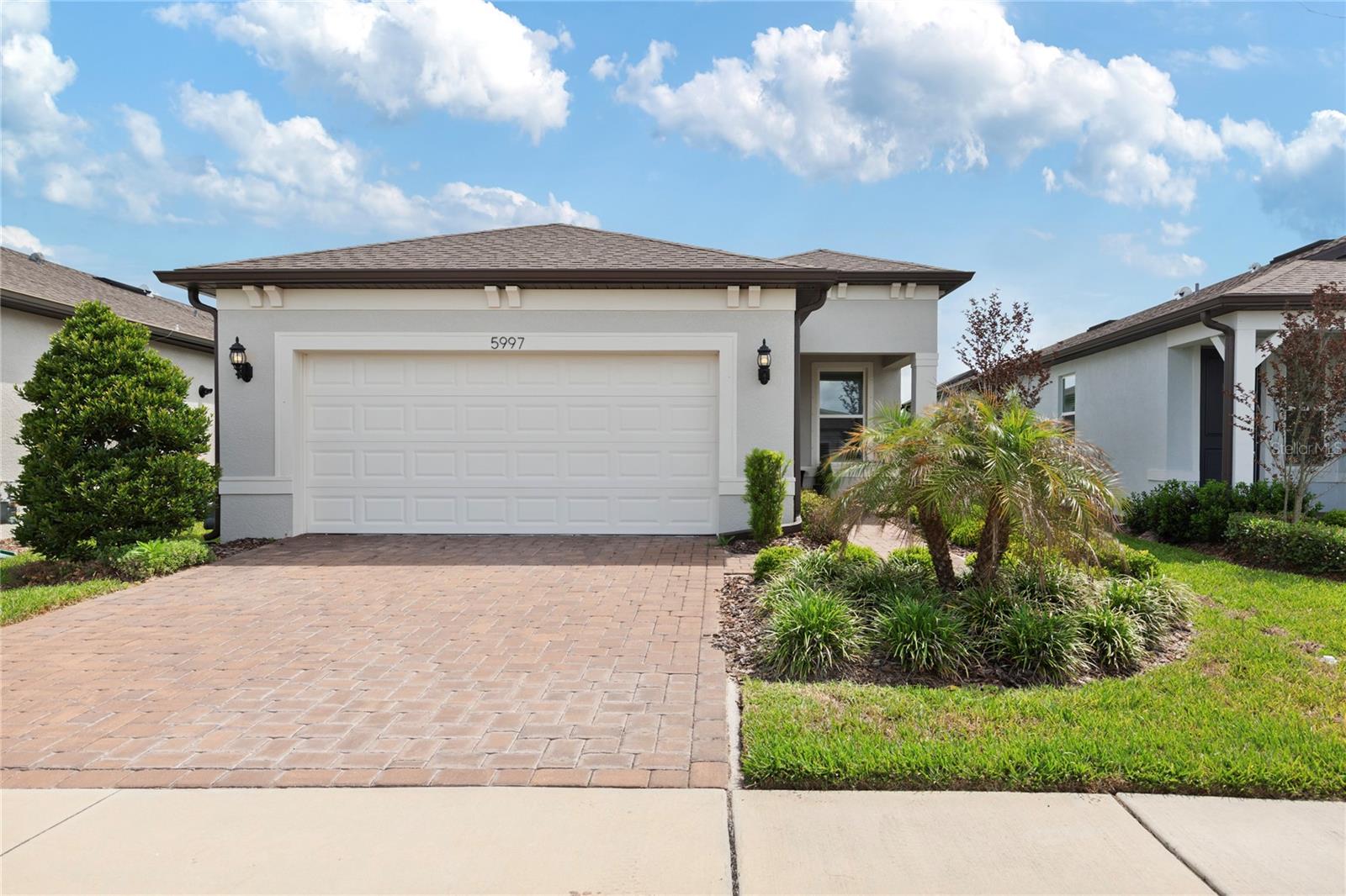 Welcome to "Del Webb," a beautiful community located in the heart of the Tampa Bay Area in Land O' Lakes. This is the perfect place for anyone aged 55 and older who is looking for an active lifestyle, social opportunities, and convenient access to local venues.This contemporary-style home, with its Mediterranean exterior, is ready for you! This fabulous residence features 2 bedrooms, 2 bathrooms, and a 2-car garage, all designed with an easy-to-care-for great room floor plan. The community offers numerous amenities as well as the home, including lawn care, a TANKLESS GAS WATER HEATER, and all essential appliances. Enjoy the EPOXY-painted garage flooring, a customer-friendly floor plan, and so much more!The layout includes a private OFFICE SPACE, two spacious bedrooms (including a primary bedroom with an en-suite bathroom), large entertaining areas, and a well-lit kitchen with ample natural light. The kitchen features white contemporary cabinets, including two corner cabinets with lazy Susans, STAINLESS STEEL APPLIANCES (including a French-door refrigerator, natural GAS RANGE, built-in microwave, large stainless steel kitchen sink, and dishwasher), plus a large island with QUARTZ COUNTER TOP that serves as additional serving or eating space.The primary bedroom is situated at the rear of the home and includes a double sink vanity with QUARTZ counter top, a large walk-in shower with a niche and decorative listello, a transom window, a linen closet, and a spacious walk-in closet. The secondary bathroom includes a 6-foot soaking tub and an upgraded showerhead.There’s never a dull moment within the community, with plenty of activities to enjoy, including a restaurant, pickleball, a dog park, tennis courts, a pool, a gym, social events, and friendly neighbors! Plus, you’re conveniently close to shopping, restaurants, Publix, banks, medical and dental facilities, and much more. This community feels like a vacation every day! Call today for your private showing!