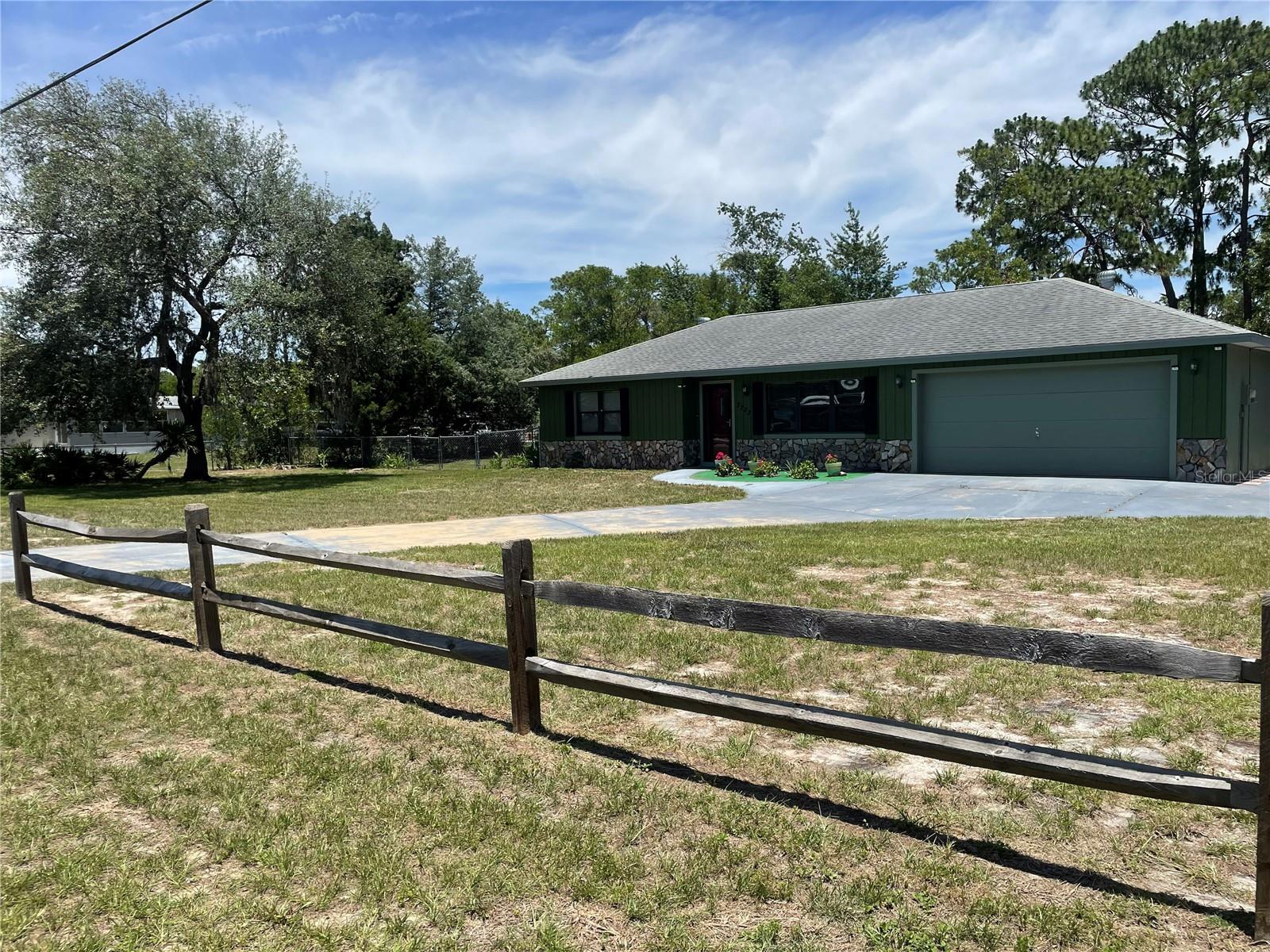 Fall in love with this immaculate 2-bedroom, 2-bath home situated on a spacious 0.62-acre lot! The fully fenced backyard offers privacy and plenty of room to enjoy the outdoors, complete with two matching storage sheds—one equipped with electric service (currently disconnected).From the moment you arrive, you'll appreciate the pride of ownership reflected throughout this well-maintained property and its beautifully landscaped yard. A spacious 17' x 14' screened room was added in 2020, creating the perfect space for relaxing or entertaining year-round.The large, open kitchen was updated a few years ago and features newer appliances. Additional updates include energy-efficient double-pane windows installed in 2020 and waterproof vinyl flooring throughout the main living areas.Enjoy peaceful views of nature from the screened back porch, or make use of the versatile bonus room equipped with its own split unit A/C, currently used as a music room but ideal as a home office, guest room, hobby space, or potential third bedroom.As an added bonus Garage has it's own Split unit A/C making the potential for a great opportunity to build out a master suite with private bath or game room , the seller is including the LG Thin Q Smart washer and dryer, along with the extra refrigerator located in the garage.Major improvements provide peace of mind, including a dimensional shingle roof installed in 2012 and a newer A/C system replaced within the last two years.With NO HOA and NO deed restrictions, you'll have the freedom to truly make this property your own. Bring your imagination and re-imagine this wonderful space to fit your lifestyle!
