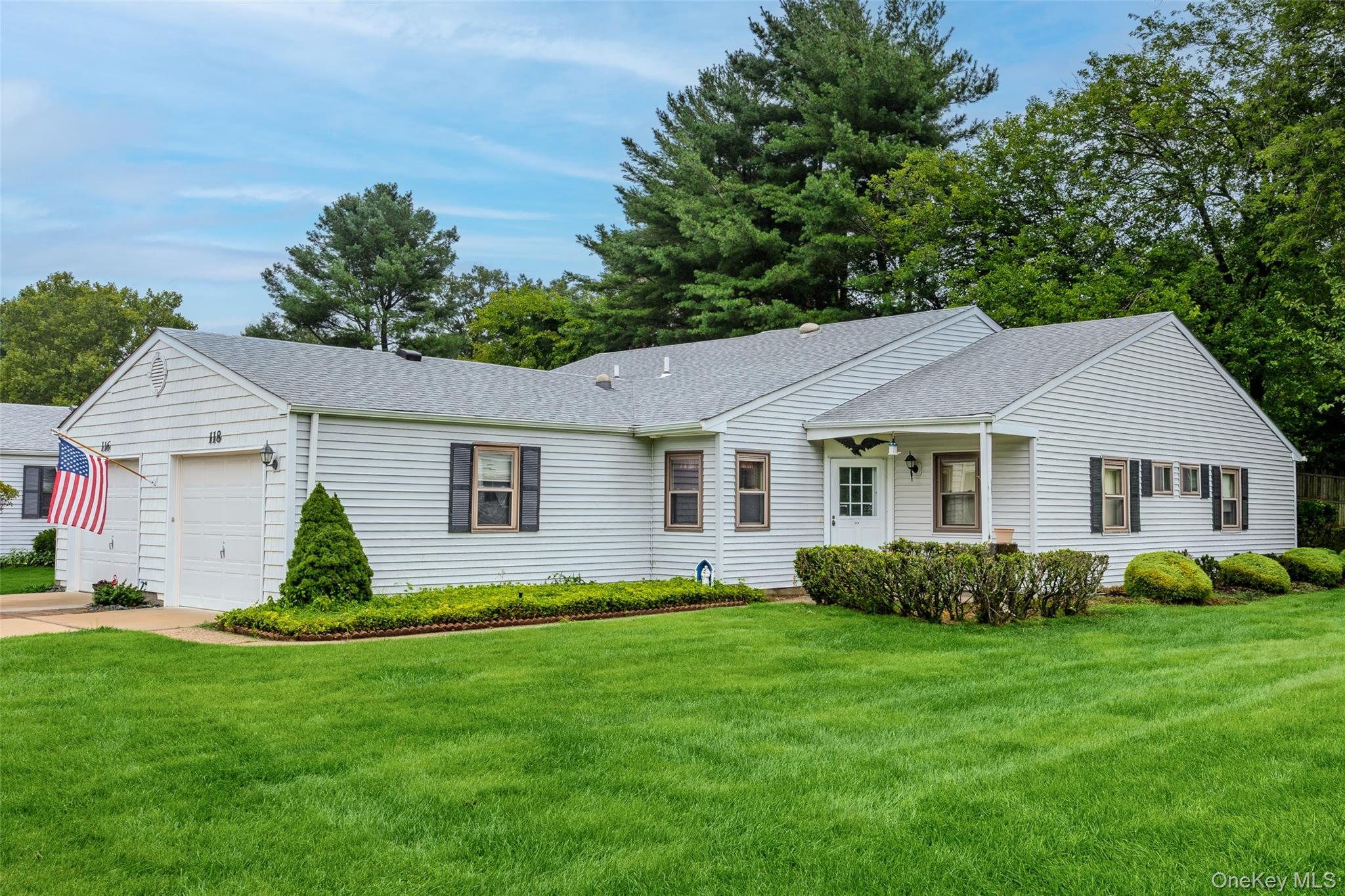 Welcome to The Knolls, a 55+ community in Stony Brook! This beautifully maintained end-unit condo offers 2 bedrooms, 2 full bathrooms, and a comfortable, spacious layout. A bright sunroom provides the perfect spot to relax and leads out to a back patio for enjoying the outdoors. The home also features a one-car garage and the added privacy of an end-unit location. Residents of The Knolls can enjoy community amenities including a clubhouse and pool. Conveniently located near shopping, dining, and all that Stony Brook has to offer, within the Three Village School District.