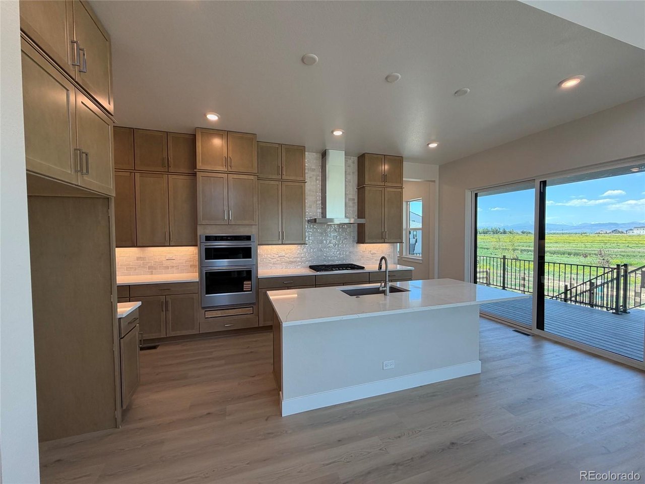 This completed Trumark Homes Plan 3 at Kitchel Lake features an oversized 4-car garage with a farmhouse elevation style. This expansive two-story plan offers 3,733 Sq. Ft. of finished living space, including the finished basement. Beyond the entry hall is the gourmet kitchen featuring 42" deluxe cabinetry with soft close features, quartz counter tops with tile backsplash, stainless steel Kitchen Aid appliance package with a 5-burner gas cooktop, a convection oven, a built-in microwave, and a dishwasher. Great pantry for even more storage! The kitchen conveniently connects to the pocket office and the covered outdoor room - great way to expand your main floor living space. Convenient main floor bedroom is a great place for a secondary office or guests. Upstairs, you'll find a welcoming bonus room for reading, tv watching, gaming or hobbies. The two secondary upstairs bedrooms are connected by a jack-n-jill bathroom with dual sinks. Down the hall, the primary suite offers a luxurious, spa-like bathroom with a walk-in shower, freestanding tub and an expansive walk-in closet. This home features the Diana Plus design finish package with extensive luxury vinyl plank flooring, luxurious carpet in bedrooms, contemporary bath fixtures, a tankless water heater, dual zoned heating, air conditioning, solar rough-in and much more! The basement is finished with bedroom, bathroom and recreational room. This home comes fully landscaped and fenced and backs to open space. What a great value - and even better - lender incentives are available on this special home!