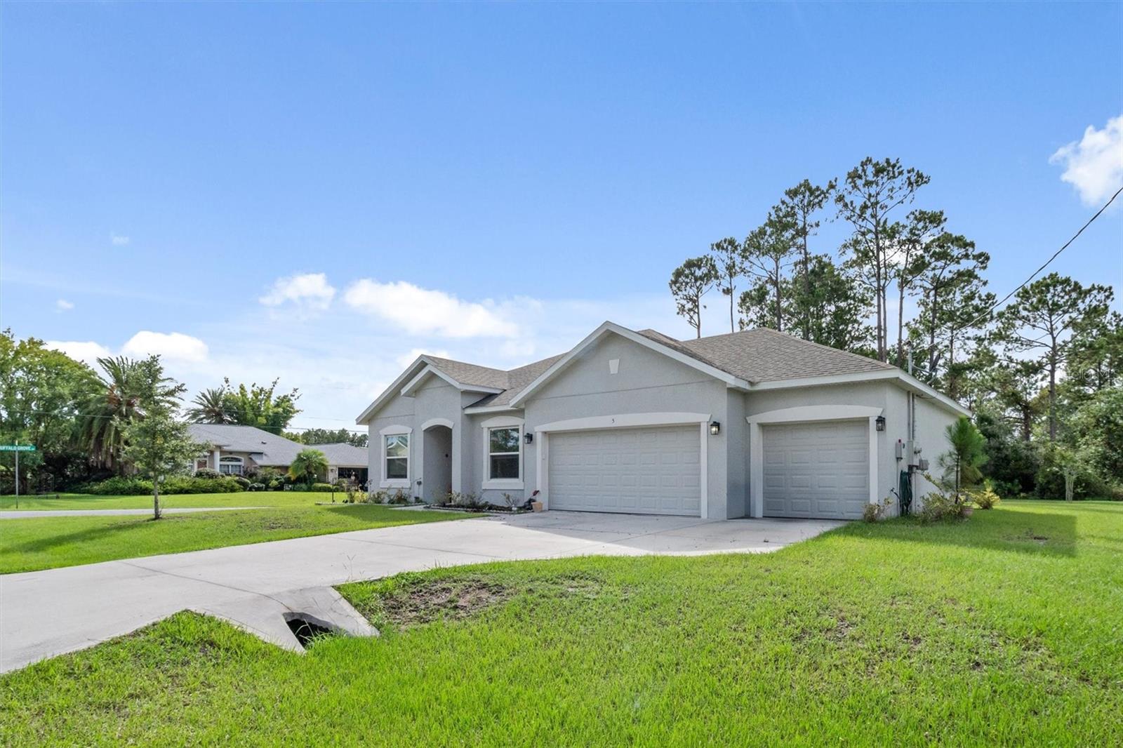 Welcome to this stunning 2021-built home nestled on a spacious corner lot! This 3-bedroom, 2-bathroom property features a desirable 3-car garage and thoughtful layout with a dedicated dining room and versatile office space—perfect for working from home or a quiet retreat. The kitchen impresses with quartz countertops, wood cabinetry, stainless steel appliances, and a generous island ideal for entertaining. Enjoy the open-concept family room with high ceilings, creating a bright and airy feel throughout. The primary suite includes a walk-in closet and a beautifully appointed bathroom with dual vanities. Step outside to the screened-in back patio and enjoy the privacy of an oversized lot—ideal for relaxing or future outdoor plans. Close to the beach, schools, resturants, parks, shopping and the interstate is within close proximity.   Also, about 30 minutes from St. Augustine, 40 minutes from Daytona beach and an hour and a half to Orlando! Don’t miss this well-maintained home with space, style, and comfort!