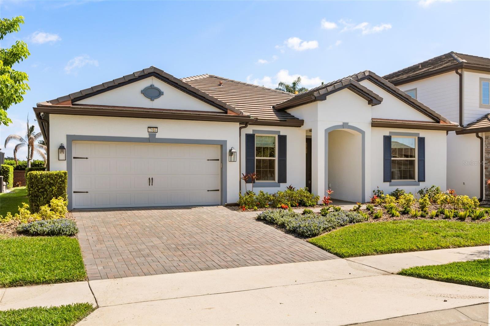 Completely reimagined from top to bottom within the last year, delivering a level of finish and function that far surpasses its original build. This exceptional 5-bedroom, 4 full bathroom residence is nestled within the exclusive gated enclave of Phillips Grove, but yet right in the heart of Orlando's coveted Dr. Phillips corridor, offering the rare combination of designer finishes, resort-caliber outdoor living, and an address that needs no introduction. A striking arched stucco entry and navy craftsman door with glass insets welcome you into an open, light-filled floor plan anchored by wide-plank wood-style flooring and walls of sliding glass that frame the pool beyond. The chef's kitchen is flawlessly appointed with custom white cabinetry, sintered stone countertops, a herringbone blue-gray tile backsplash, gas cooktop, double wall ovens, and a farmhouse sink beneath three oversized ribbed glass dome pendants on champagne bronze accents. The adjacent walk-in butler?s pantry, complete with custom shelving, pull-out baskets, and a built-in beverage refrigerator, is a true luxury addition. The primary suite is a sanctuary in every sense, featuring a tray ceiling, spa-inspired marble-style tile bath with a capiz shell chandelier, soaking tub, frameless glass walk-in shower with subway tile and bench, dual lighted vanity mirrors, and a beautifully organized custom walk-in closet for two. The secondary ensuite, plus the jack-n-jill bedrooms/bathroom suites offer endless possibilities. Three additional full bathrooms, including a newly converted fourth, a rare and highly valuable upgrade, are each finished with sintered stone countertops, updated vanities, commodes, fixtures, and designer lighting. Outside, the living and entertaining space is elevated by a disappearing pocket sliding glass door that tucks entirely behind the wall, erasing the boundary between indoors and out and opening the home to a screened lanai with dual ceiling fans, outdoor TV prewire, fenced yard, a pristine pool with an in-water sun lounge chair area, paver decking, and a sleek outdoor kitchen with grill and beverage fridge create effortless Florida indoor-outdoor living at its finest. A designer mudroom with built-in cabinetry and utility sink, and the 5th bedroom with French doors currently envisioned as a beautifully bright and airy executive homework space with statement chandelier, and impeccable attention to detail throughout complete this extraordinary offering.
