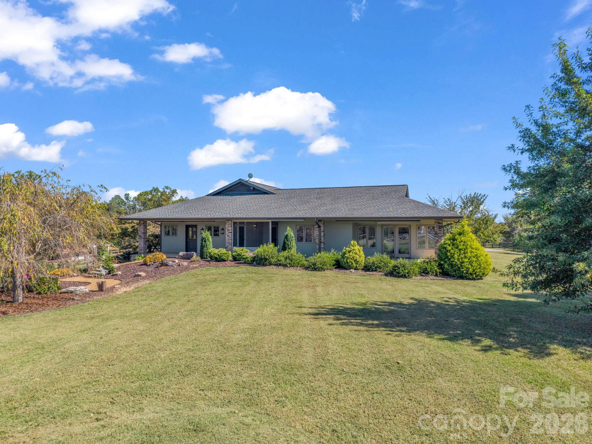 Welcome to an exceptional 17.28-acre equestrian estate combining tranquil country living, pasture views, sunrise/sunset vistas, and access to private community riding trails. Designed for main-level ease of living, this custom ranch home with 2,277 sq. ft. of living space features a bright great room with abundant windows, a stone gas fireplace, and an impeccably updated gourmet kitchen and dining area with a large granite island. Practical features include a large mudroom/laundry for easy transitions from the barn, a covered screened patio off the kitchen, and a rear patio boasting an artificial waterfall and cozy firepit. The spacious primary bedroom features dual walk-in closets. The primary bath serves as a luxurious retreat featuring radiant heated floors, a deep soaking tub, separate walk-in shower, and dual separate sinks. Enjoy your own private home golf amenities featuring a personal putting green, sand trap, and tee box. Additional property highlights include a separate studio guest home with a Murphy bed, kitchenette, and full bath, plus an adjoining workshop and separately fenced small animal pen/chicken coop. The 17.28 acres feature gentle slopes and are fully enclosed with secure no-climb fencing, including all three pastures. Top-tier equestrian infrastructure includes a massive 200' x 125' riding arena with a viewing gazebo, a covered 50-foot round pen, a 3-stall barn with feed/tack storage and a covered wash stall, and a secondary 2-stall barn with storage. There is a separate gated entrance to the barn area for trailer access and an equipment shed. Approximately 3m to TIEC! A rare, turn-key lifestyle property!