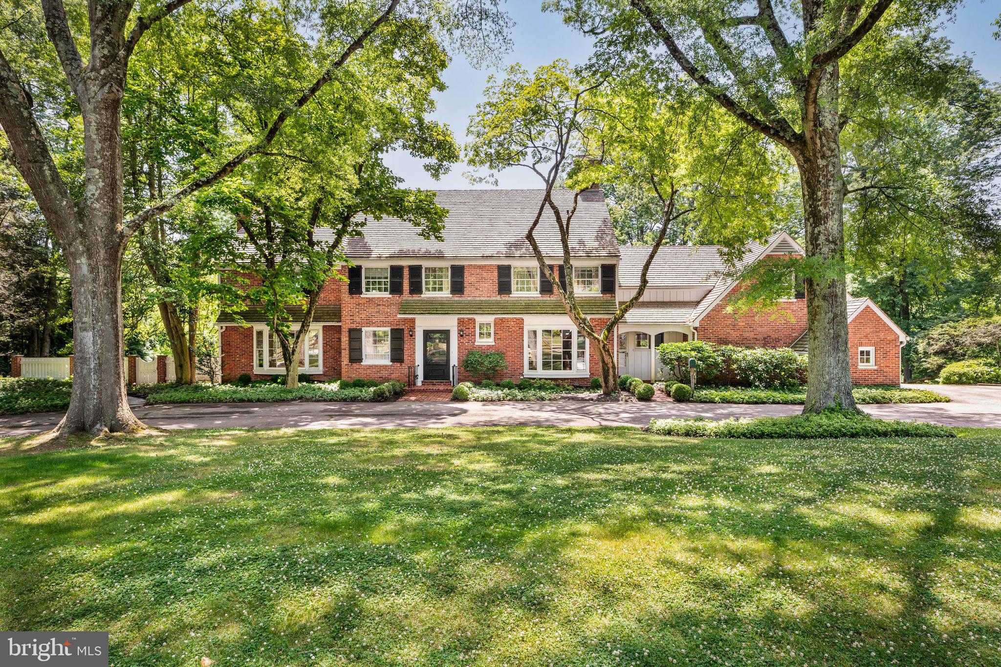 OPEN HOUSE SAT JULY 11 is CANCELLED!! On 1.89 acres on the north side of Villanova, this all-brick colonial with a newer cedar roof offers a combination of location, setting, construction, and curb appeal that is rare at any price.The outdoor setting is exceptional. A swimming pool with flagstone deck, a covered terrace directly off the living room, a second terrace off the dining room, and a rolling lawn with mature specimen trees create an outdoor environment suited equally to quiet enjoyment and entertaining at scale. The natural rear boundary gives the property a privacy and visual depth that the acreage alone does not explain.Inside, pegged oak hardwood floors and a curved staircase set the tone at the entry. The living room has extensive millwork, a bay window, fireplace, and wet bar, with a door opening directly onto the covered terrace. The paneled study — wrapped floor-to-ceiling in wood, with a fireplace and bay window on two exposures — is a room with its own distinct character. The dining room opens through French doors to the rear terrace. The kitchen has hardwood floors, a gas cooktop, and a breakfast area with views to the grounds; an adjacent mudroom with laundry connects to the two-car garage.The primary suite occupies an entire wing of the second floor: sitting room, office, bedroom, and bath. Three additional bedrooms and two full baths complete the second floor. A fifth bedroom and full bath are on the third floor. The finished lower level is daylit, walk-out, and opens directly to the rear grounds — substantially extending the home's capacity for family use and casual entertaining.Whole-house propane generator. Two-car garage. Lower Merion School District.