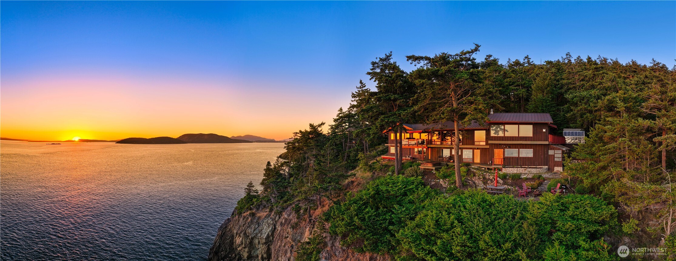 A masterful expression of PNW architecture, this extraordinary estate is perched atop a dramatic bluff overlooking Rosario Strait, the San Juan Islands, and endless open-water vistas. Privately situated on 2.16 acres in coveted Biz Point, this fully remodeled residence blends timeless timber-frame craftsmanship with modern luxury. Soaring cedar ceilings, exposed beams, and walls of glass create a seamless connection between the home's stunning interior and the coastal landscape beyond. Nearly every room captures water views, breathtaking sunsets, and the beauty of the islands. At the heart of the home, thoughtfully designed living spaces offer warmth and sophistication, anchored by custom woodwork, fireplaces, and exceptional architectural detail. The chef's kitchen flows effortlessly into entertaining areas, while the primary suite features a tranquil bathroom, oversized walk-in closet, fireplace, and commanding water views. Outdoor living includes multiple view decks, a waterfront firepit, hot tub, and gathering spaces designed to experience the sights and sounds of the Salish Sea. Add. amenities include a detached garage, shop, greenhouse, EV charging, wired generator, gated entry, and beautifully maintained grounds. Rarely does a property combine iconic architecture, complete privacy, and world-class waterfront views. Just minutes from downtown Anacortes, this is a rare opportunity to own one of the PNWs most captivating coastal estates.