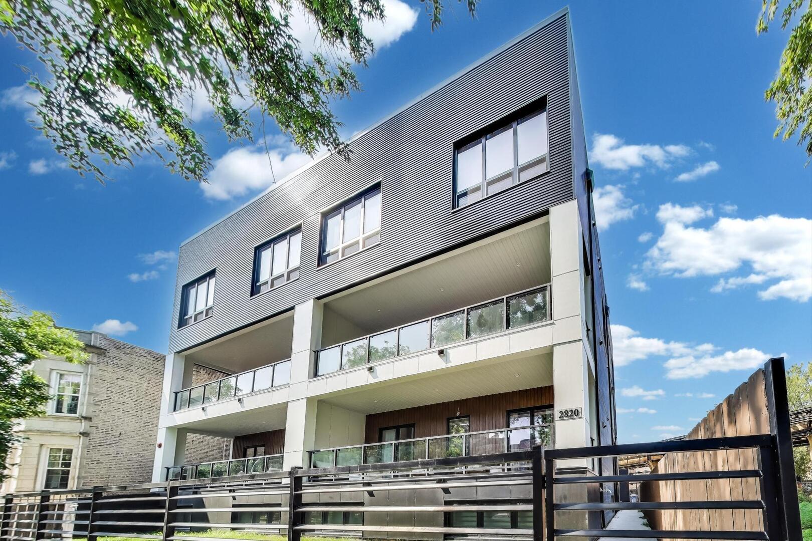 Luxury Modern Living in Prime Logan Square | 2023 New Construction Corner Unit Steps from the Blue Line. Welcome to this stunning 2-bed, 2-bath corner-unit condo, ideally located in the heart of Logan Square-just a 2-minute walk to the California Blue Line. Built in 2023, this newer construction home boasts designer finishes, a smart open-concept layout, and sun-drenched living spaces thanks to expansive windows in every room. Step inside to find wide plank white oak flooring flowing throughout the main living areas, complemented by soaring ceilings and abundant natural light. The chef's kitchen is a showstopper, featuring custom cabinetry with sleek black hardware, a dramatic full-wall brick backsplash, quartz countertops, a large eat-in island, and high-end Samsung black stainless steel appliances-perfect for entertaining or quiet mornings at home. The spacious primary suite is a true retreat, complete with a large walk-in closet, custom lighting, a floating double vanity, and a luxurious walk-in shower with a rainfall showerhead and floor-to-ceiling porcelain tile. The second bedroom is fully outfitted with a custom Murphy bed, making it ideal as a home office, guest room, or both. The second bath includes a deep soaking tub, a custom glass door, and elegant tile finishes. Enjoy indoor-outdoor living with a covered balcony featuring a gas hookup, outlet, and finished in low-maintenance Trex decking, perfect for savoring coffee at sunrise or cocktails at sunset. Additional highlights include triple-pane windows for superior soundproofing, a full-size Samsung washer/dryer, and heated garage parking with an EV charger hook-up and additional outlet included in the price.