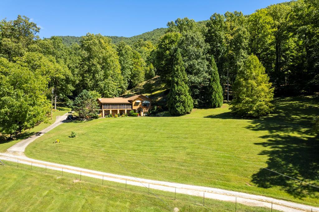 The perfect country estate is a park like setting  just 15 minutes from town and 5 minutes from fabulous Lake Santeetlah. Encompassing 46.47 acres including large home, groomed and fenced pasture, picturesque pond, multiple streams, 2 barns, tool shed.  This spacious 4360 sq ft. custom built home comes with an attached double car garage. The beautiful home with new deck provides room for great entertaining. This property could be your wonderful equestrian facility, a private retreat or year round home in the mountains.  Expanded in 1995 and updated periodically, this 3 bedroom, 3  bath home offers the perfect balance of grand and intimate spaces.