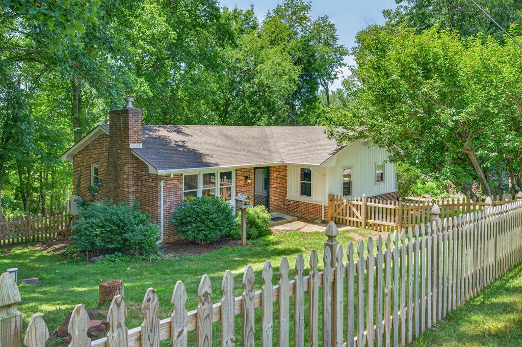 Remodeled 3BR/2BA home within walking distance of downtown Floyd! Situated on a quiet, shaded lot with mature trees, this property features a fenced front yard for dogs, a private backyard, and a storage shed. The beautifully updated kitchen offers soft-close cabinets, stone countertops, a farmhouse sink, and dining area that opens onto the living room for an inviting open floor plan. Two spacious bedrooms and a full bath are on the main level. The finished walk-out basement includes a large family room, full bath, laundry area, and a versatile non-conforming third bedroom with a large walk-in closet, ideal for guests, a home office, craft room, or gym. With its private entrance, the lower level offers potential for an apartment or in-law suite. Enjoy modern updates, flexible living space, and a convenient location near downtown shops, restaurants, and amenities.