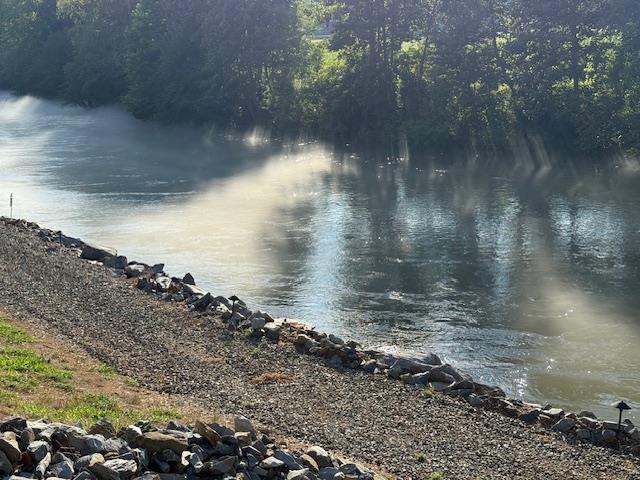 A Touch of Heaven!! Bordered on one side by a beautiful rock base creek and on the other side there is over 300' of frontage on the Notley River!!  150' X 25' of large local rock and soil line the river bank. 200'X 50' of soil has been brought in to raise the property above the flood plane.  Property features 4 sites backing up to the river that have water, septic and 50 AMP service with room for multiple trailers and there's also camping along the creek. There's a 30'X 60' Metal Building with a 15'X 60' lean-to on the river side and a 15'X 20' on the back with roll up doors.  The building is equip with a 200 AMP electrical panel. lighting, water, septic and tons of gravel.  All electric it backed up by a Generac Generator.  Housed in the building is a 2021 Mobile Suite Luxury DRV 5th Wheel.  You will love the way the landscape lighting makes the river come alive at night!!  The possibilities are endless: Campground, Private Estate or Family Compound.  If you can Dream it, you can Do it!!