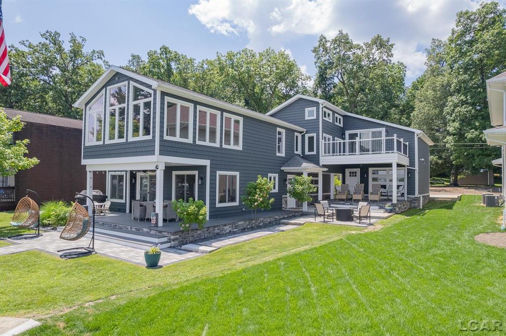 Experience the ultimate lakeside getaway in this breathtaking compound, offering nearly 3000 square feet of luxurious living space. With 5 spacious bedrooms plus 2 charming sleeping lofts, including a convenient first-floor bedroom, this home is designed for comfort and accessibility. The opulent primary suite serves as your personal retreat, featuring a spa-like bathroom, dual walk-in closets, and a private balcony to savor stunning sunrises. Outside, enjoy an expansive outdoor living area complete with covered decks, a cozy firepit, and a versatile garage with tandem doors, perfect for parking or entertaining. Plus, the additional backlot provides ample parking or the exciting potential for a future carriage house.