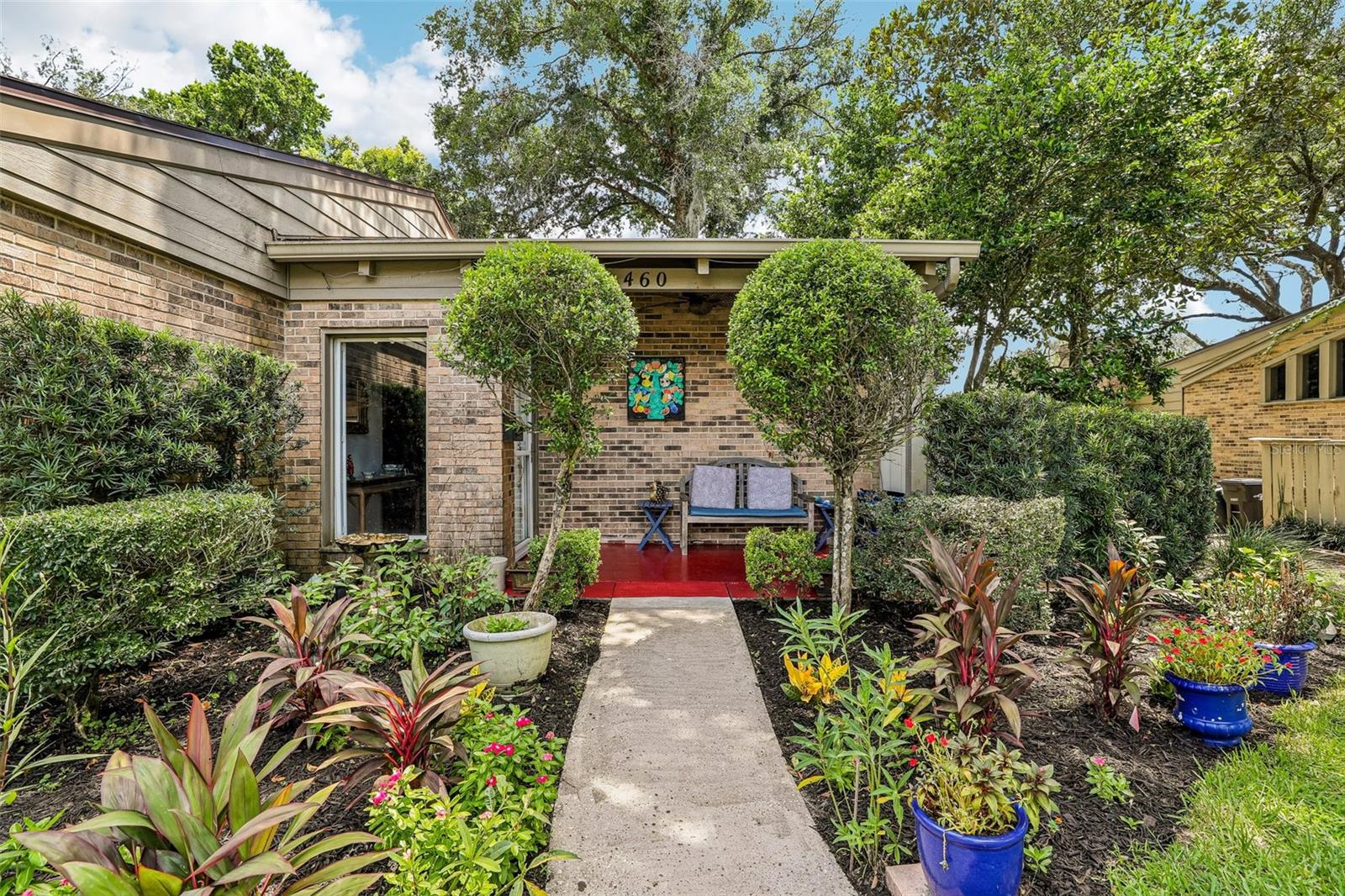 RARELY AVAILABLE ONE-STORY END-UNIT in the sought-after GATED WATERFRONT COMMUNITY of Oak Harbour. Distinctive architectural details define this exceptional residence, featuring soaring TONGUE-AND-GROOVE WOOD CEILINGS with exposed beams, CUSTOM BUILT-IN BOOKCASES, and walls of windows that fill the home with natural light. A versatile BONUS ROOM adapts to your lifestyle as a home office, library, studio, or den. The renovated primary bath showcases a beautifully updated WALK-IN SHOWER with timeless finishes. At the same time, the PRIVATE BACKYARD is highlighted by a majestic oak tree and an inviting deck designed for outdoor living. Ideally situated directly across from the COMMUNITY POOL and TENNIS COURTS, this home is also just steps from LAKE ORIENTA, where residents enjoy a covered fishing dock, PRIVATE BOAT LAUNCH, boat and watercraft storage, and direct lake access for boating, kayaking, canoeing, and paddleboarding. Oak Harbour offers a true RESORT-STYLE LIFESTYLE with TWO SWIMMING POOLS, a beautifully appointed clubhouse, fitness center, sauna, tennis, pickleball, basketball, and shuffleboard courts. Mature oak trees, beautifully maintained grounds, and HOA-COVERED EXTERIOR MAINTENANCE AND LANDSCAPING provide a carefree, low-maintenance lifestyle. Ideally located just minutes from ALTAMONTE MALL, CRANES ROOST PARK, ADVENTHEALTH, SUNRAIL, INTERSTATE 4, and WINTER PARK, this home offers an exceptional combination of architectural character, outstanding amenities, and one of Central Florida's most convenient locations.