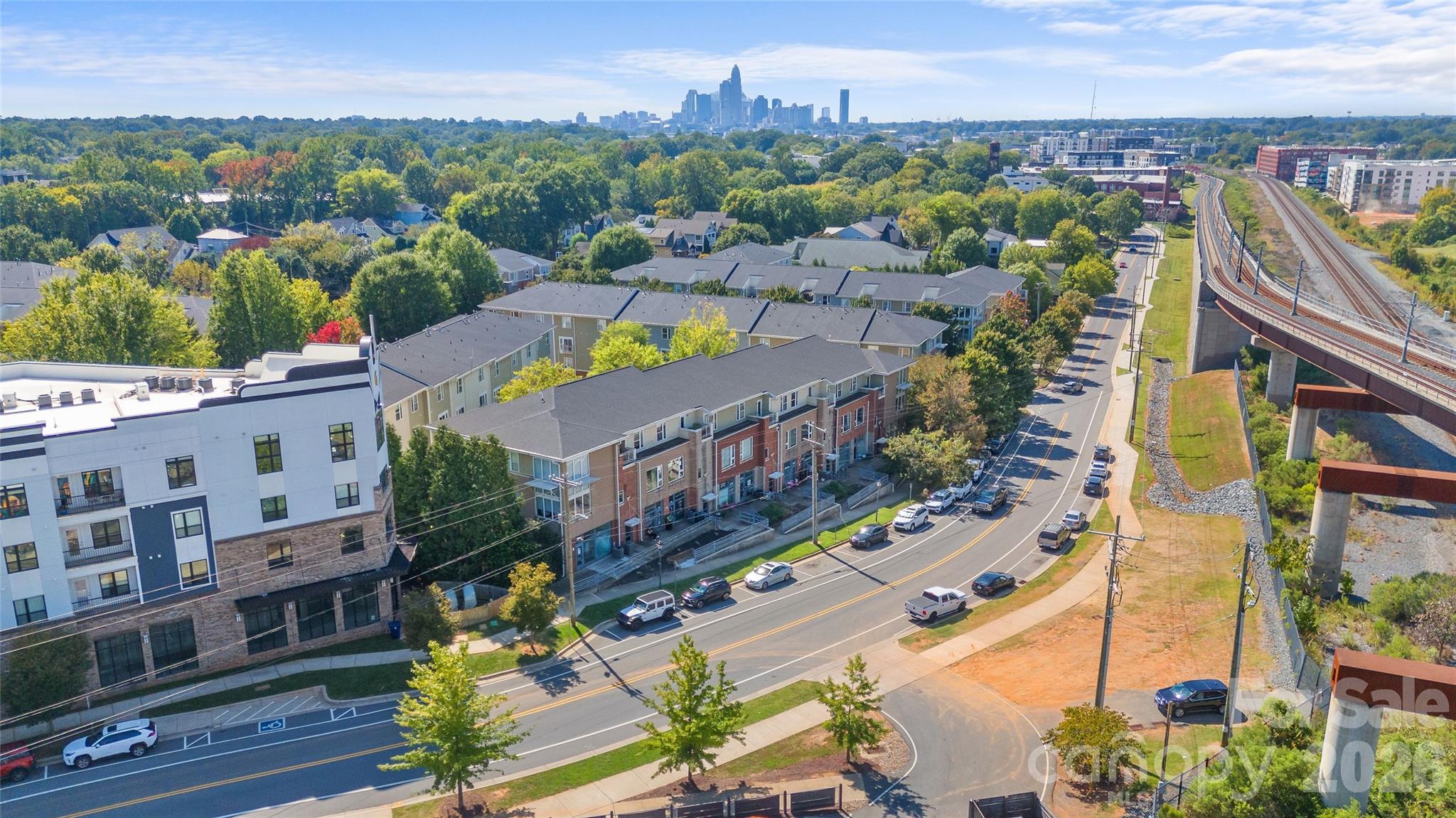 A custom kitchen, two bedroom suites and a separate creative space give this NoDa condo a personality all its own. Located in The Renaissance, this 2-bedroom, 2.5-bath home pairs thoughtful interior details with easy access to the neighborhood’s restaurants, coffee shops, breweries and live music. The remodeled kitchen features marble hexagon tile, custom copper detailing, wood countertops, shaker cabinetry with glass knobs and open shelving with copper supports. A farmhouse sink, stainless steel appliances, statement lighting and an island complete the space, while a breakfast bar connects the kitchen to the living area. Durable wood-look tile runs throughout the main level, where an open layout offers room for living, dining and entertaining. Flush-mounted ceiling speakers for a seven-channel surround sound system and in-wall wiring for an HD projector set the stage for movie nights at home. A convenient half bath serves the main level. Upstairs, both bedrooms feature prefinished hardwood flooring and their own full bathrooms, and the spacious primary suite opens to a private balcony. Set above ground-floor businesses in one of the community’s rare mixed-use buildings, the condo has no residential neighbors above or below. A one-car garage adds everyday convenience, while a standout feature awaits just across from it: a separate 220-square-foot, temperature-controlled flex/storage room with internet wiring. Whether you need room for creative projects, hobbies or additional storage, this space offers possibilities rarely found in a condo. Enjoy the community pool, explore NoDa’s colorful murals, local shops and music scene, or head to the nearby 36th Street light rail station for Blue Line access to Uptown, South End and beyond.