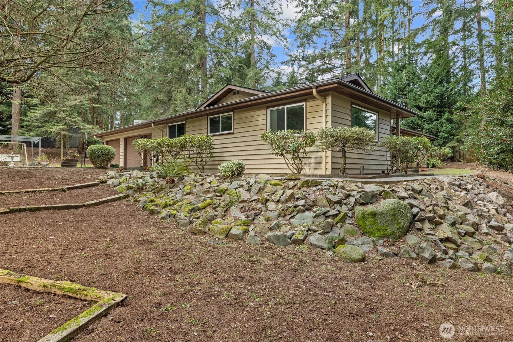 This single-level ranch-style home is tucked away in a secluded Enumclaw neighborhood on private .85-acre retreat offers the perfect blend of peaceful country living and everyday convenience. Set back from the road, the property is surrounded by mature trees and gently rolling landscaping, creating a serene, park-like setting. The home is filled with natural light thanks to built-in skylights and updated vinyl windows. Thoughtful finishes include Corian countertops, extensive tile and laminate flooring, and a warm, inviting layout designed for both comfort and functionality. A generously sized office provides an ideal work-from-home space or additional area for entertaining.  Step outside and unwind in your own wooded getaway, complete with a charming gazebo—perfect for relaxing and enjoying the tranquility of nature. The property also offers abundant storage, RV parking, and a large shop space ready for hobbies, tools, or recreational toys.  Major updates provide peace of mind, including new gutters (2022), an energy-efficient Rheem heat pump (2023), and a brand-new roof (2025). Ideally located close to both the mountains and the city, this home delivers privacy, versatility, and a lifestyle you’ll love! New Washer/Dryer and Range to be installed for future owner. Roll down your windows and drive through the countryside and come see why this is your next perfect home in the country! Fix and flip or develop ADU/DADU - Sellers are motivated!