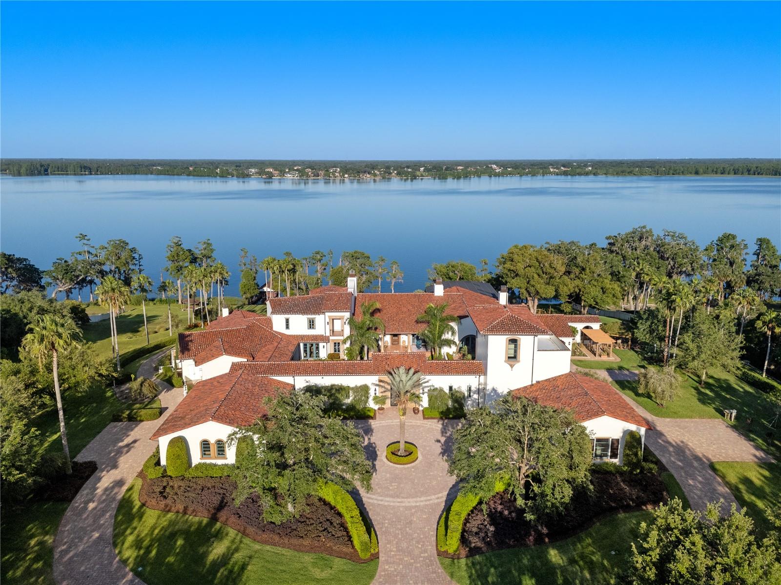 With partial owner financing available, we present an exceptional and truly rare opportunity: a distinguished lakefront estate coupled with an adjoining commercial parcel —perfectly suited for an expansive residential compound, corporate retreat, boutique hotel, or world-class wedding destination, where the possibilities are as expansive as the grounds themselves. Positioned on 22 gated acres and 682 feet of waterfrontage along Lake Thonotosassa, this residence boasts over 25,000 square feet of inspired architecture, redefining the concept of a private estate. Welcome to an iconic estate, where timeless elegance meets the serene beauty of nature. From the moment you arrive, you’ll sense the majesty of the property, the unparalleled craftsmanship, thoughtful design and breathtaking views that define this extraordinary residence. A grand entrance sets a stately tone, opening to elegant living areas and thoughtfully designed courtyards that offer tranquility and seclusion. A cheerful portico welcomes guests with colorful, professionally landscaped gardens, creating a warm and inviting first impression with vibrant seasonal blooms. Designed as a living work of art, the home features extraordinary architectural fidelity and intentional design at every turn. An immersive experience in American heritage and cultural elegance, the home includes a meticulously recreated Oval Office and a scaled replica of the famous Tampa Theatre, offering a cinematic environment rich in detail. A dedicated memorabilia room serves as a gallery of curated history. Craftsmanship with intention is evident throughout, with extensive custom millwork, precision moldings, elevated ceilings and artisanal finishes adorning every space. The estate comprises 6 luxurious suites, 12 opulent baths, and over 34,000 total square feet of inspired architecture and functionality. Unique additional rooms, terraces, galleries and conveniences are located strategically throughout. The scenic North Tower suite has a dedicated entrance and parking. Resort-style amenities offer a lagoon-inspired, tiered-level pool complete with cascading waterfall and a zero-entry edge, expansive outdoor entertaining areas and serene lake views, creating an ideal sanctuary for luxury living. This magnificent estate is suited for a discerning collector, history enthusiast or visionary seeking an enduring architectural legacy in the Tampa Bay region. But this listing is just half the story… The adjacent waterfront parcel with the commercial venue is being offered creating a once-in-a-generation opportunity to own both a luxury residence and fully operational event business. Together, the properties span 22 gated acres, making this the ultimate turnkey private residential compound or boutique hotel development, an elite corporate retreat center or a global wedding destination. Born from a dream and nurtured with love, Mision Lago is an immersive experience steeped in charm, purpose, and potential. The moment you pass through the gates, you feel the care and passion woven into every structure, every garden, every detail.  Up to 50% Seller financing available - call today for more information.