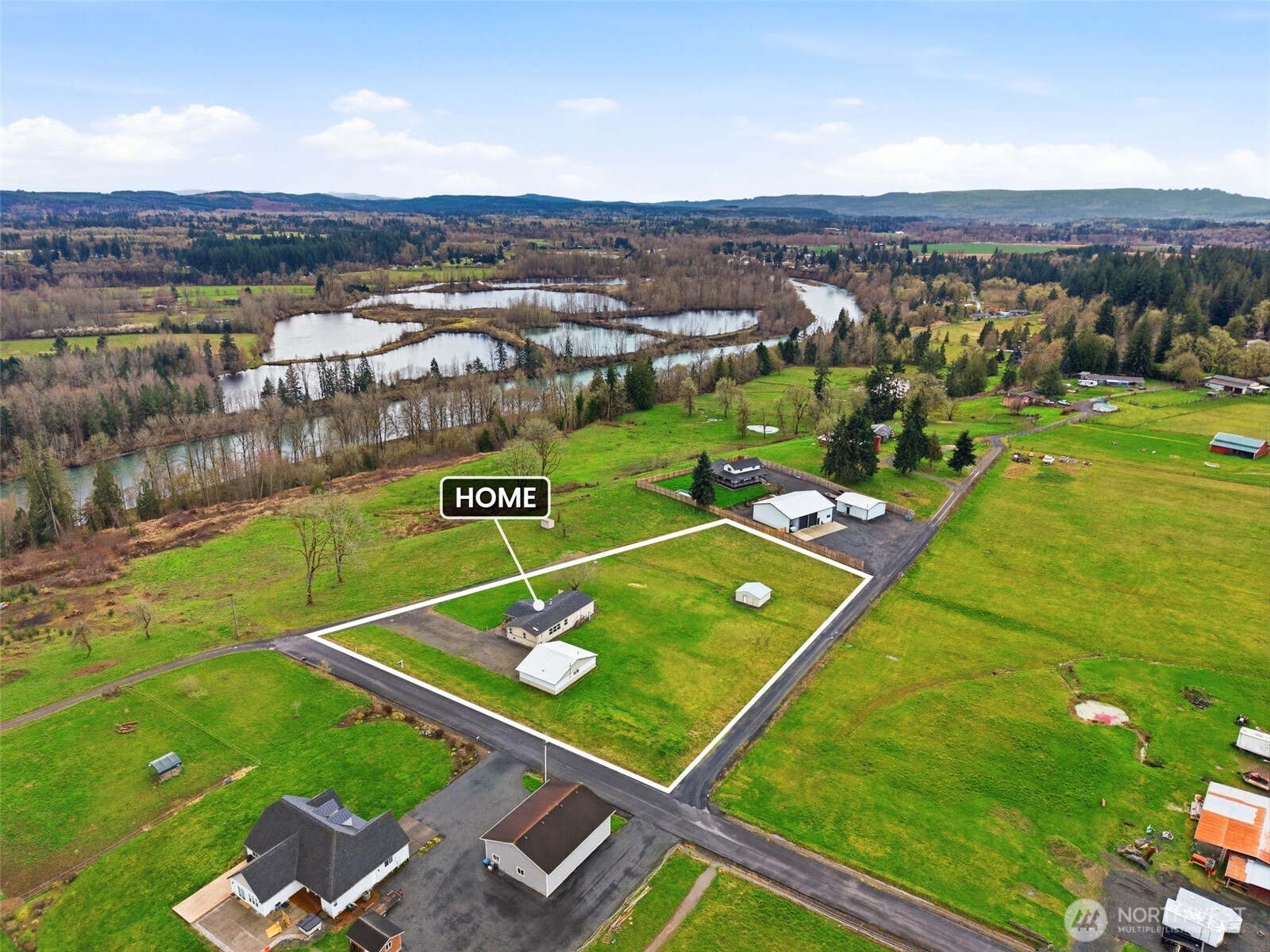 Discover the perfect blend of privacy and potential on this nearly 2-acre property in Toledo. Offering a rare combination of high-bank Cowlitz River views, unobstructed views of Mt. St. Helens and Mt. Rainier. The property features a spacious 1,950 sq. ft. triple-wide manufactured home with an open-concept 3-bedroom, 2-bathroom layout, alongside a substantial 30x40 insulated shop equipped with its own power service and concrete floors.  Home includes a bonus living space with a large TV that stays with the home and an office space. Home was recently remodeled. Remodel includes updated kitchen, new flooring, new windows, paint inside and out, new sinks and faucets, new water heater, and newer roof. Come experience the stunning mountain and river views this home has to offer! Due to recent boundary line adjustment, map is incorrect. Please refer to plat map provided in supplements or refer to Lewis County Parcels for the correct Map Information!