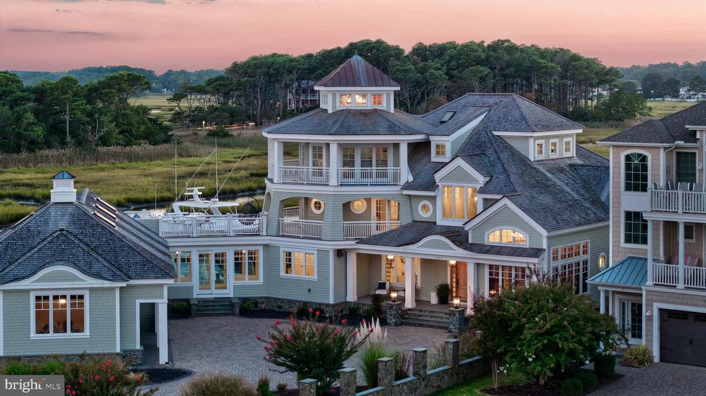 Experience refined waterfront living in this exceptional 7,350-square-foot estate in West Ocean City. Positioned with ideal southern exposure, the home captures sweeping views of Assateague Island National Park and the constant activity of the Ocean City inlet.  This custom-built residence is offered completely furnished and features six bedrooms, six full baths, and two half baths. A striking curved staircase anchors the interior, complemented by European cabinetry, expansive Pella windows and doors, and high-end finishes throughout. Radiant floor heating and geothermal systems deliver efficient, year-round comfort.Designed for both everyday living and entertaining, the layout includes spacious gathering areas, private bedroom suites, three separate laundry areas, and a dedicated captain’s quarters.  For boaters, two rare 24-foot-wide deep-water slips provide immediate access to the harbor and open ocean—an unmatched advantage in this location.  Offered at $6.9 million, this property represents a compelling value, with an estimated replacement cost near $12 million. The quality, setting, and waterfront lifestyle offered here are simply not reproducible at this price.  A rare opportunity to own a turnkey coastal estate with premier views, direct water access, and enduring craftsmanship.