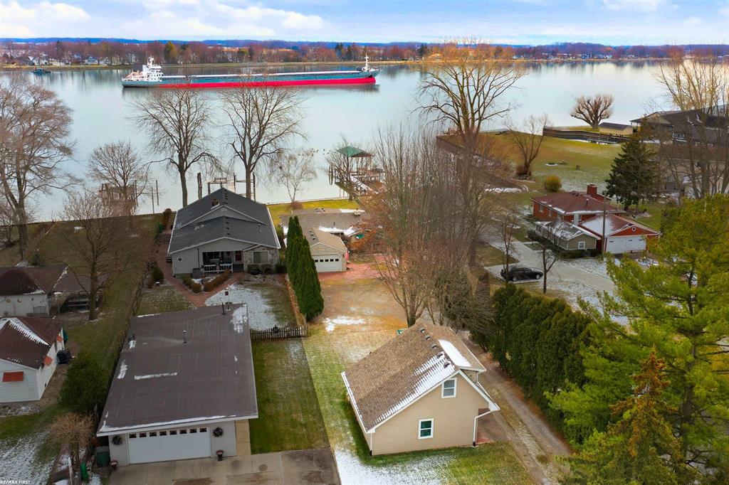 Discover this charming waterfront retreat tucked away in a peaceful, secluded setting. The open kitchen features abundant cabinet and counter space, soft-close drawers, roll-out shelves, and all stainless steel appliances included. The dining room flows seamlessly into the great room, where soaring cathedral ceilings and panoramic views of the St. Clair River create a stunning backdrop all year round. Enjoy the summer days in the bright and airy sunroom as you sip your favorite beverage and watch the boats and freighters cruise by. 3 spacious bedrooms provide comfort and versatility for family and guests. A unique loft above the detached garage offers an ideal private space for an additional bedroom, hobbies, work, or relaxation. Take advantage of the private beach in your own backyard! With two generous 22x24 detached garages, you'll have all the storage and workshop space you need. Offering both tranquility and convenience, this home feels like a private getaway while still being just minutes from local shops and restaurants. LOCATION, LOCATION, LOCATION!