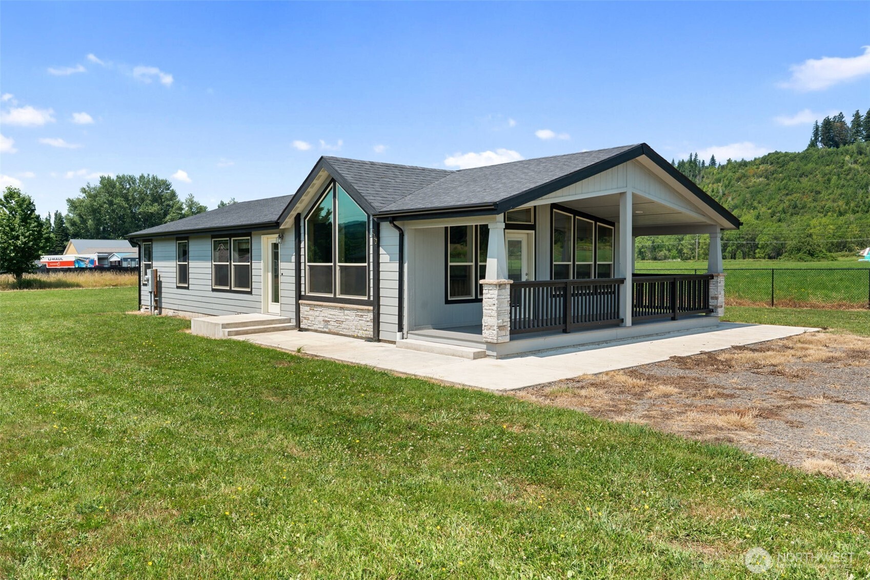 Don’t miss this spacious, modern home on a generous half acre lot in the peaceful community of Mossyrock. This move in ready home offers an open concept layout with vaulted ceilings, expansive picture windows, abundant natural light, & modern finishes throughout. The spacious kitchen features stainless steel appliances, abundant cabinetry, generous counter space, a walk in pantry, & a breakfast bar overlooking the dining & living areas. A large kitchen window overlooks the peaceful open field behind the home, while an exterior door leads to the concrete patio & spacious backyard. Featuring 3 bedrooms & 1.75 bathrooms, the private primary suite includes a large walk in closet with built in shelving & an en suite bathroom with a custom tiled walk in shower, glass enclosure, decorative tile accents, & glass block details. A separate laundry room adds convenience. The level half acre lot offers room for gardening, a future shop, or RV parking. Built on a desirable stem wall foundation. Enjoy the convenience of in town services while maintaining a peaceful small town setting. Conveniently located just minutes from schools, parks, shopping, restaurants, medical services, & everyday amenities. Just minutes from Mayfield Lake & Riffe Lake for boating, fishing, hiking, camping, & year round recreation.