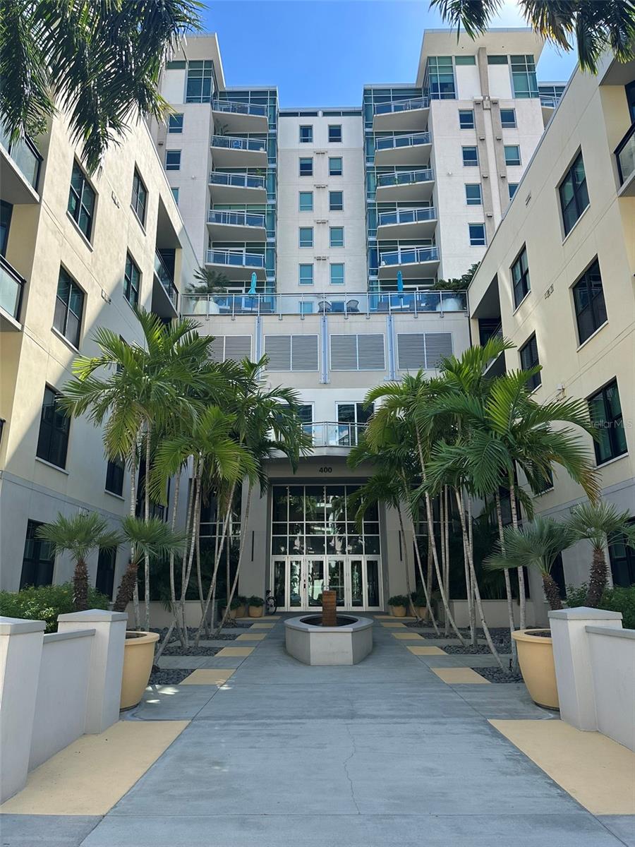 RARE TOP-FLOOR CORNER PENTHOUSE WITH BREATHTAKING DOWNTOWN AND WATER VIEWS | THE SAGE, DOWNTOWN ST. PETERSBURGExperience elevated urban living in this exceptional 12th-floor corner residence at The Sage, ideally situated in the heart of vibrant Downtown St. Petersburg. Offering a rare combination of soaring 11- to 12-foot ceilings, dramatic floor-to-ceiling windows, spectacular city and water views, and an unbeatable location, this stunning 2-bedroom, 2-bathroom condo with a separate den captures the very best of downtown living.From the moment you step inside, the expansive windows and impressive ceiling heights create a wonderful sense of space and light, drawing your attention to the captivating views of the downtown St. Petersburg skyline and surrounding waterfront. Enjoy partial bay and harbor views from your south-facing private balcony, where you can relax and take in the beauty and energy of the city.The thoughtfully designed split-bedroom floor plan offers privacy and versatility, while the separate den provides the perfect space for a home office, reading retreat, or occasional guest accommodations. The open kitchen features a breakfast bar and flows seamlessly into the dining and living areas, creating an inviting setting for everyday living and entertaining. A separate laundry room adds convenience and functionality.What truly sets this residence apart is its desirable top-floor corner location and exceptional combination of features. The property includes two assigned garage parking spaces and a private storage unit conveniently located on the same floor—valuable amenities in the heart of downtown. The HOA fee covers FiOS internet, building insurance, water, sewer, trash, reserves, maintenance, elevator service, and security, offering added convenience and value.The Sage offers an appealing collection of amenities, including a community swimming pool, BBQ area, fitness center, and clubhouse, allowing you to enjoy relaxation and recreation without leaving home.Perfectly positioned just a three-minute walk from Central Avenue, the Dalí Museum, and the downtown waterfront, this residence places you moments from the city's celebrated restaurants, cafés, galleries, cultural attractions, and waterfront destinations.Combining soaring ceilings, expansive windows, flexible living space, desirable parking and storage, and an exceptional downtown location, this rare top-floor corner residence presents a wonderful opportunity to experience the best of urban living in St. Petersburg.